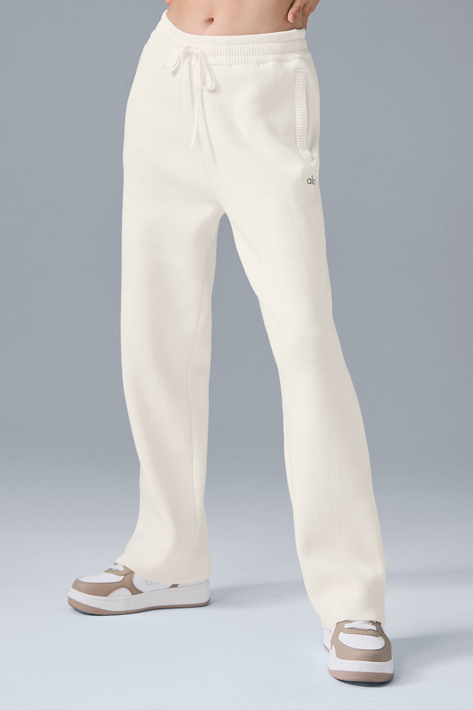 Model wearing ivory wide leg sweatpants with relaxed baggy fit