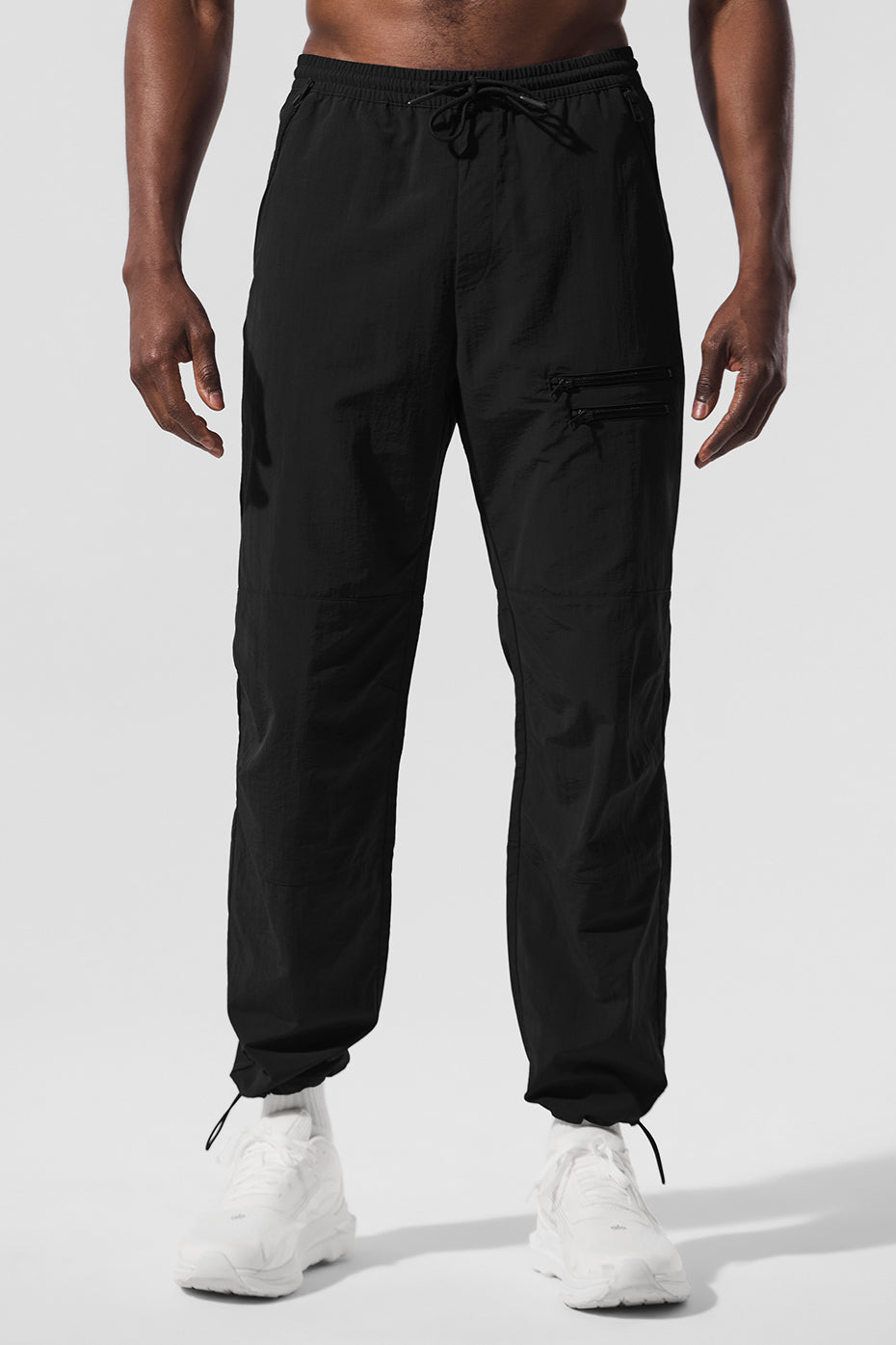 Front view of Urban Jogger Pants for Men in black, showcasing zippers and pockets.
