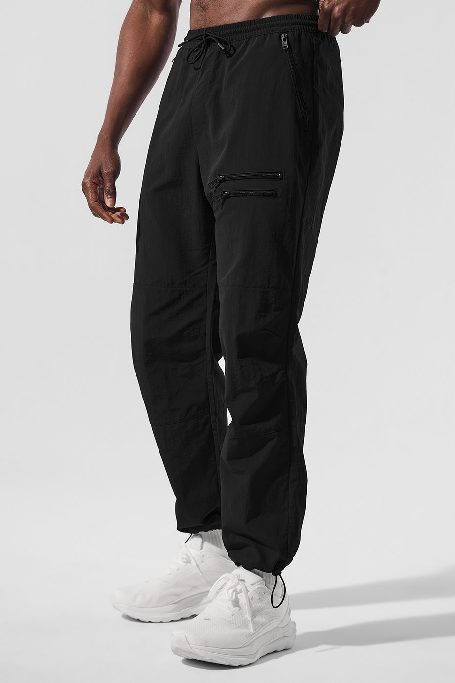 Front view of Urban Jogger Pants for Men in black, showcasing zippers and pockets.