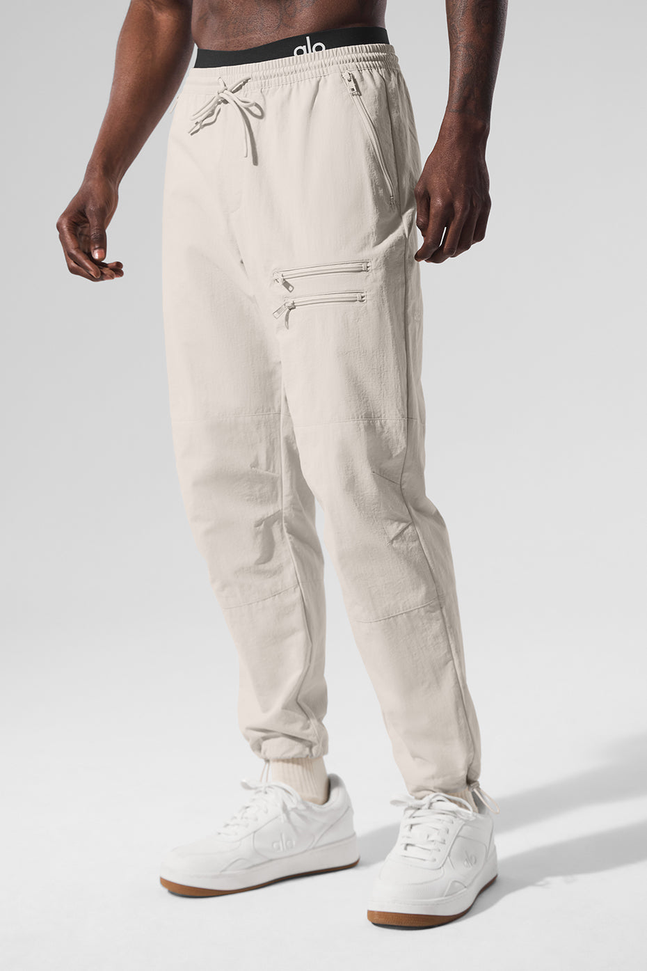 Side view of retro joggers for women in Bone, showcasing zippered pockets.