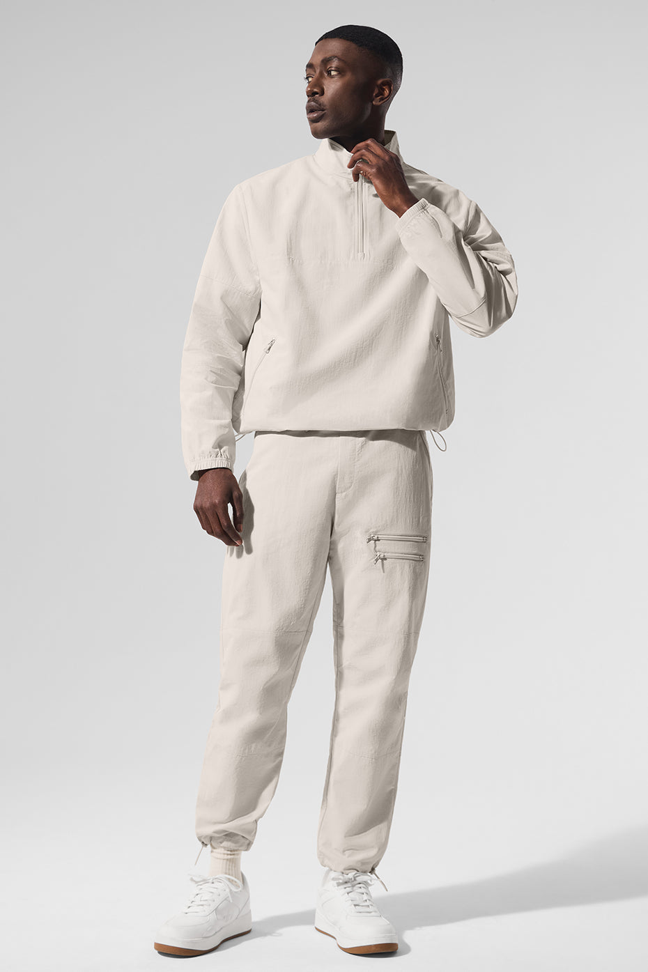 Side view of retro joggers for women in Bone, showcasing zippered pockets.