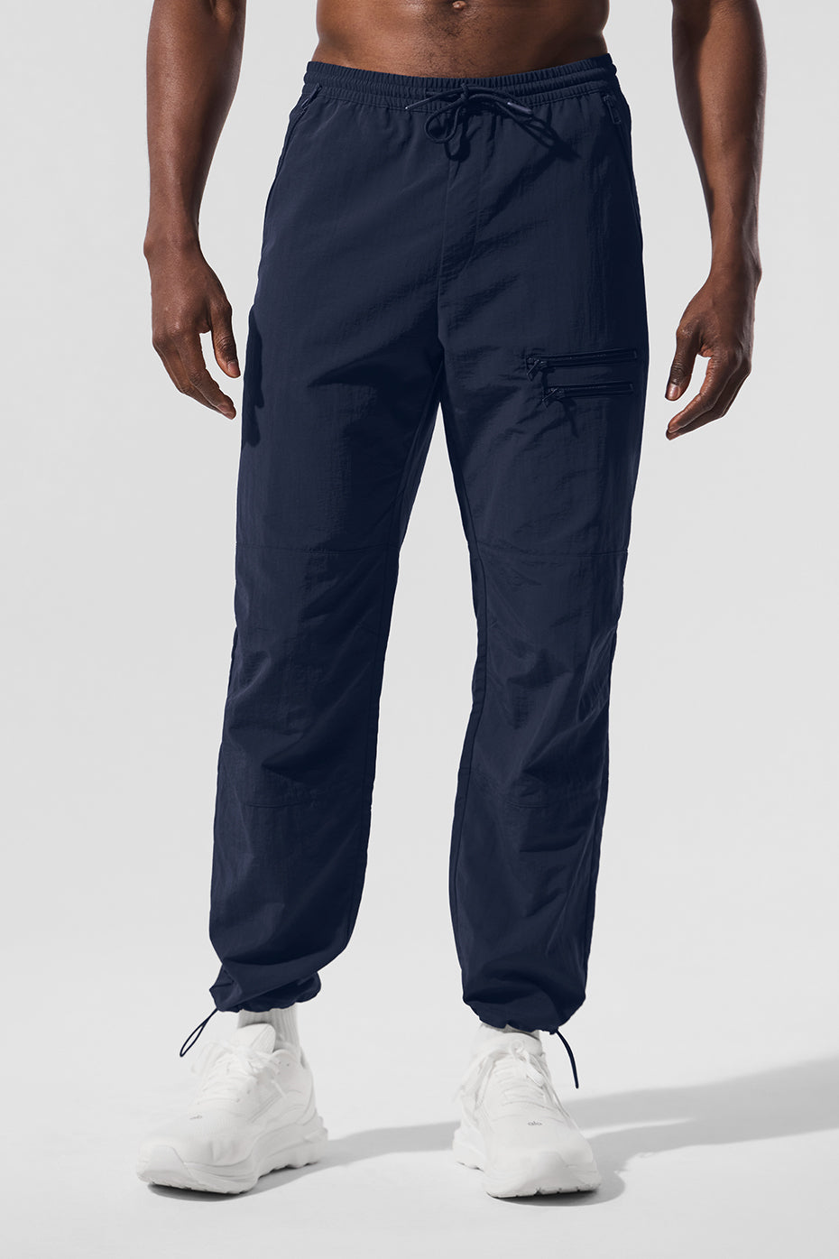 Close-up of navy joggers with zippered pockets and sleek fabric for activewear