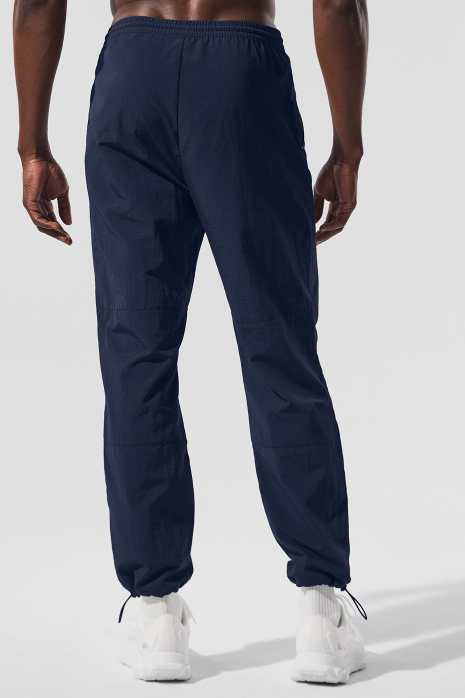 Front view of navy joggers showing zipper details and drawstring waist for a comfortable fit