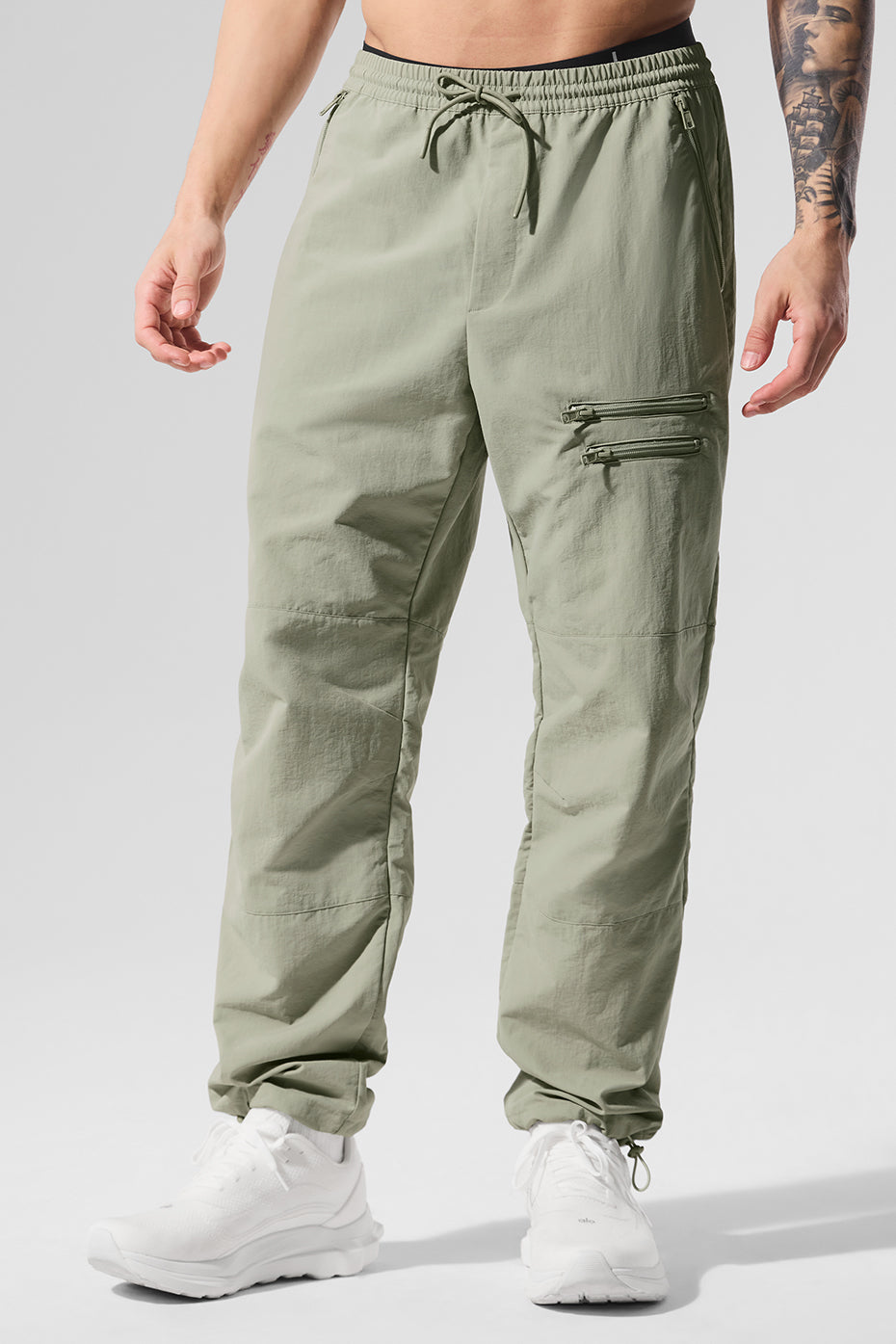 Front-facing view of black joggers worn casually on city streets