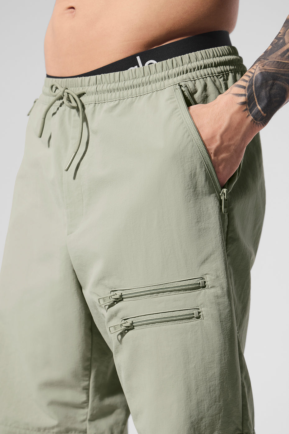 Close-up of pants track zipper details and drawstring waistband