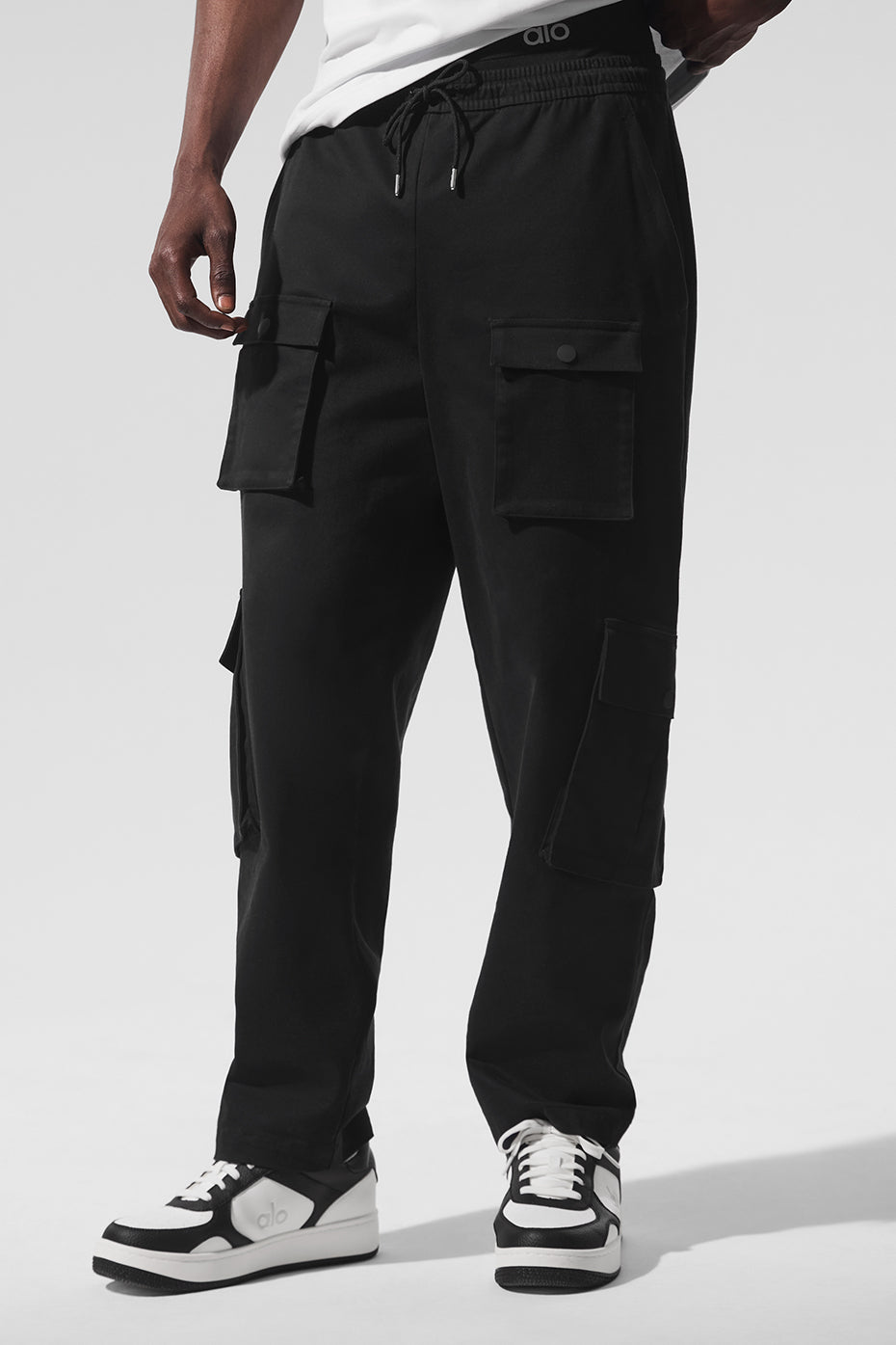 Front view of black cargo pants for women, showcasing pockets and fit.