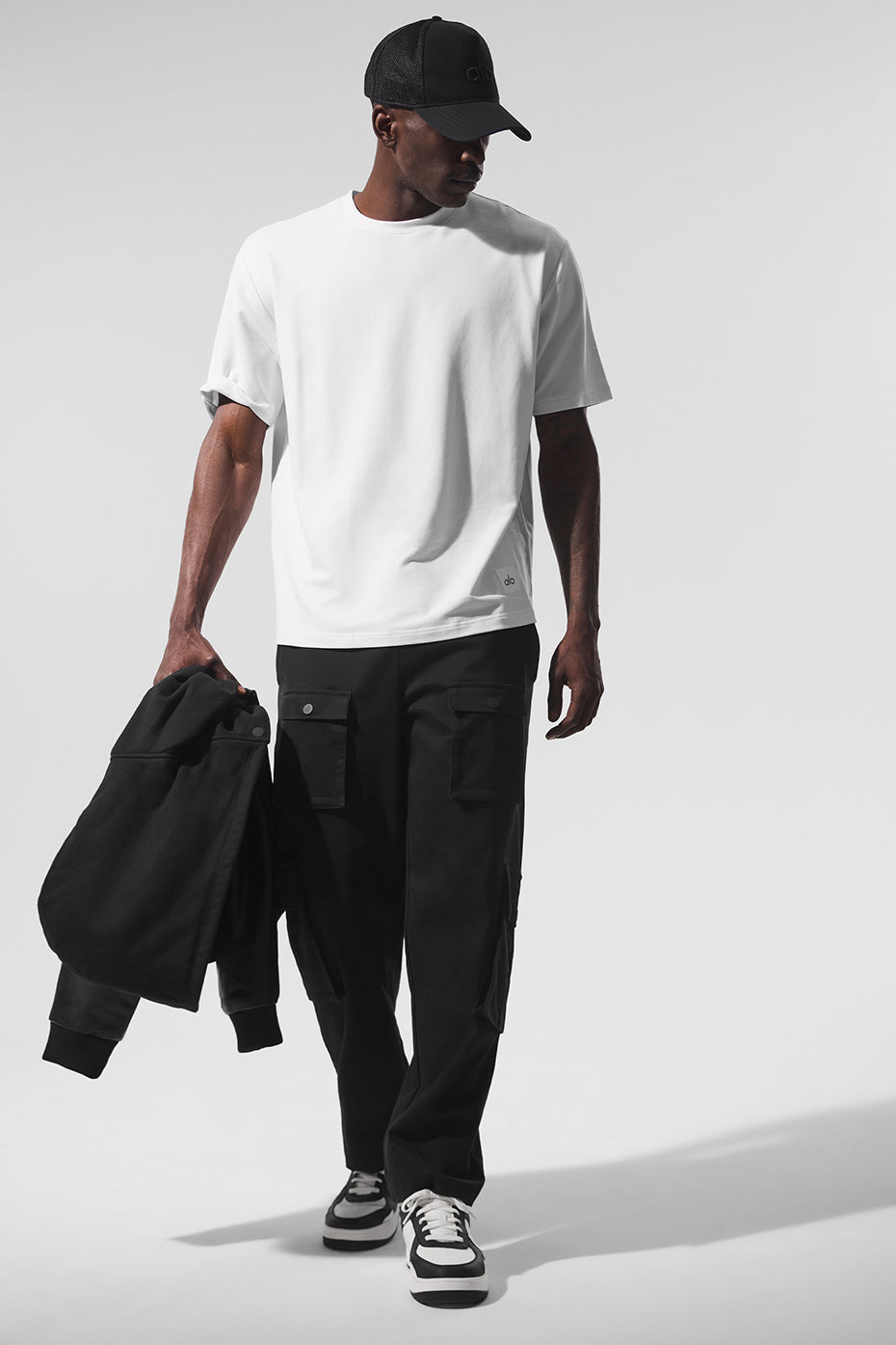 Front view of black cargo pants for women, showcasing pockets and fit.