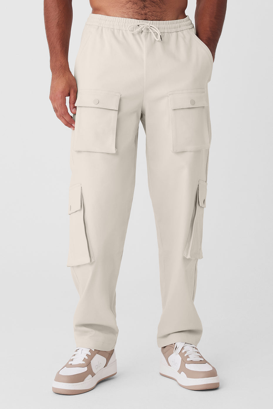 Front view of Y2K cargo pants in bone color, highlighting the elastic waist and pockets.
