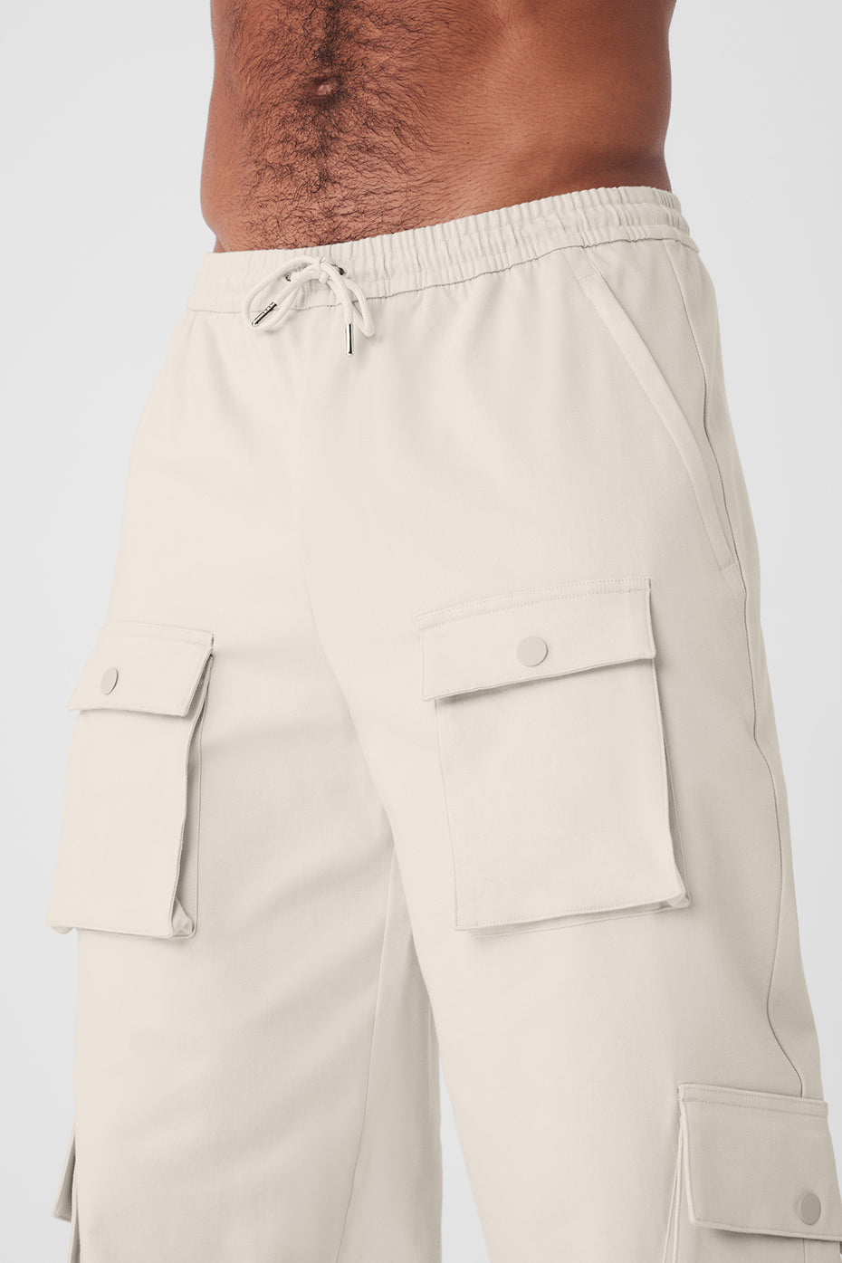 Front view of Y2K cargo pants in bone color, highlighting the elastic waist and pockets.