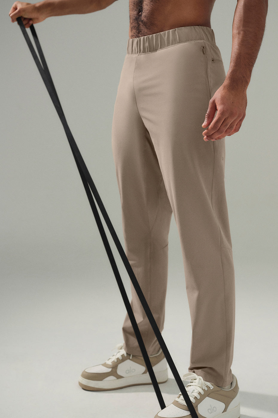 Model wearing Elevate Performance Pants, styled with a crew neck for a casual look.