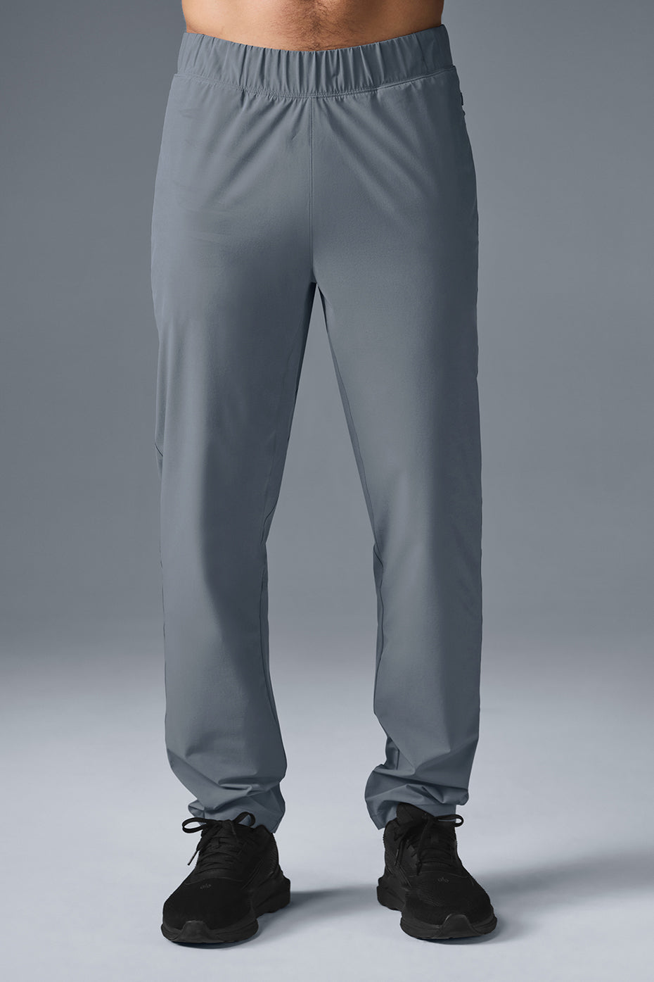 Steel gray performance pants showcased outdoors on a sunny day.