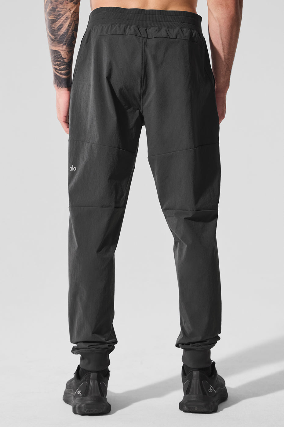 Flat lay of athleta linen pants highlighting waistband and zip pocket features.