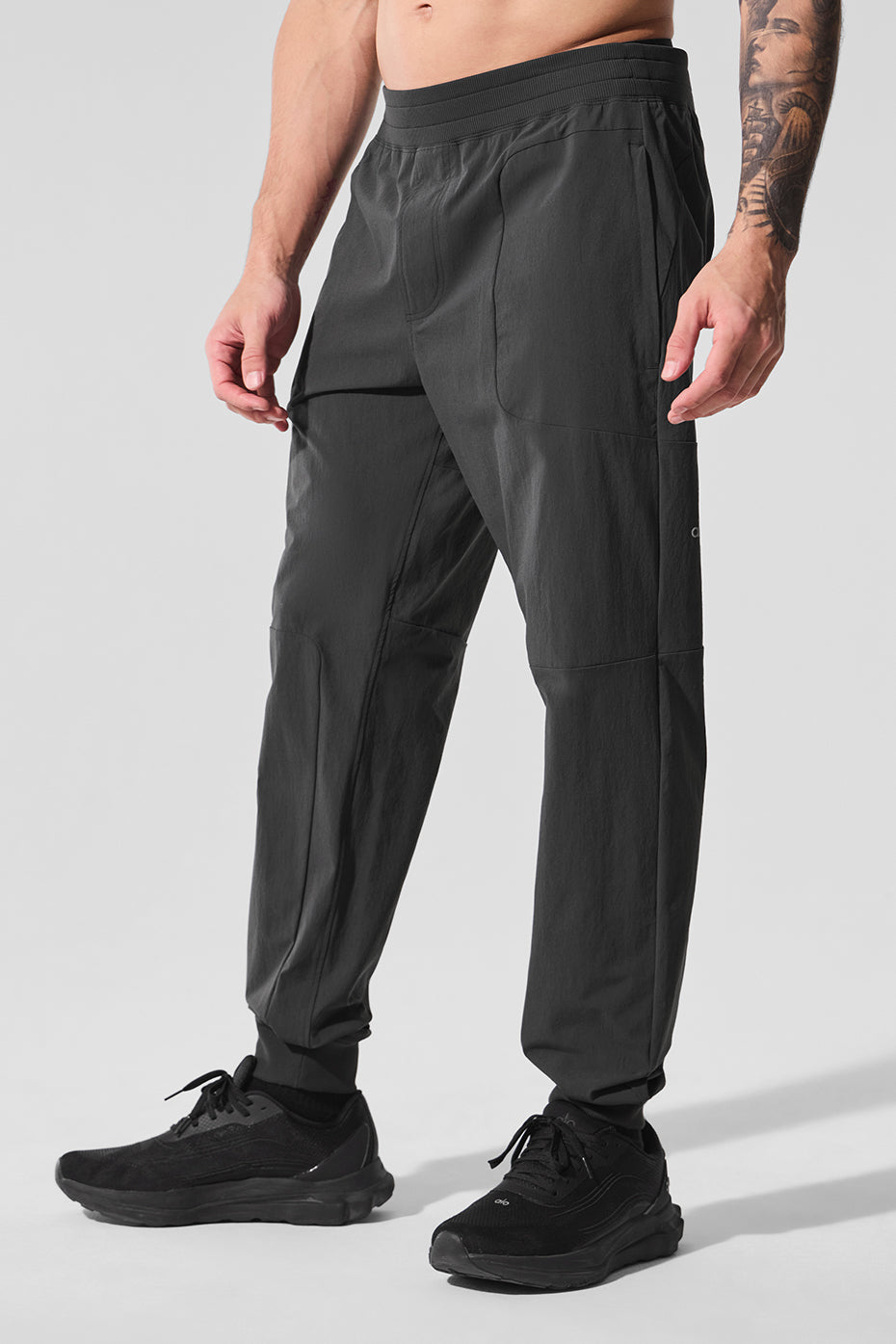 Close-up detail of seaming and water-repellent fabric worn during leg day workout.