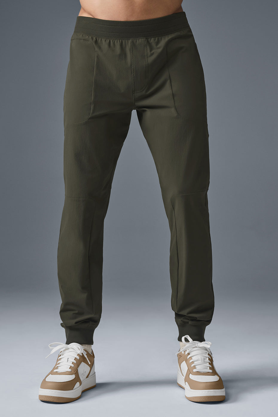 Side view of stealth green high-performance yoga pants during a yoga session.