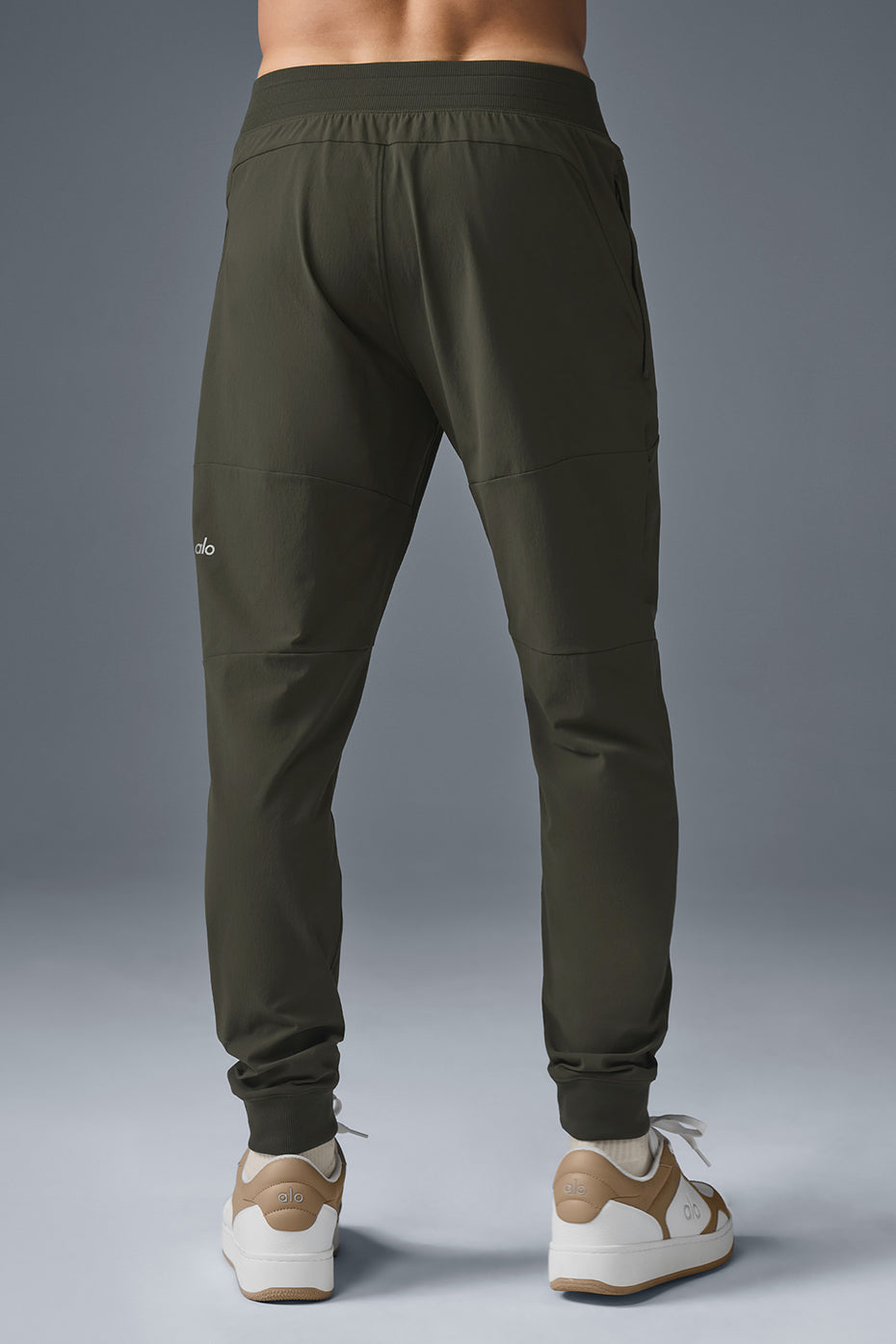 Close-up of the elastic waistband and side-zip pockets on yoga pants.