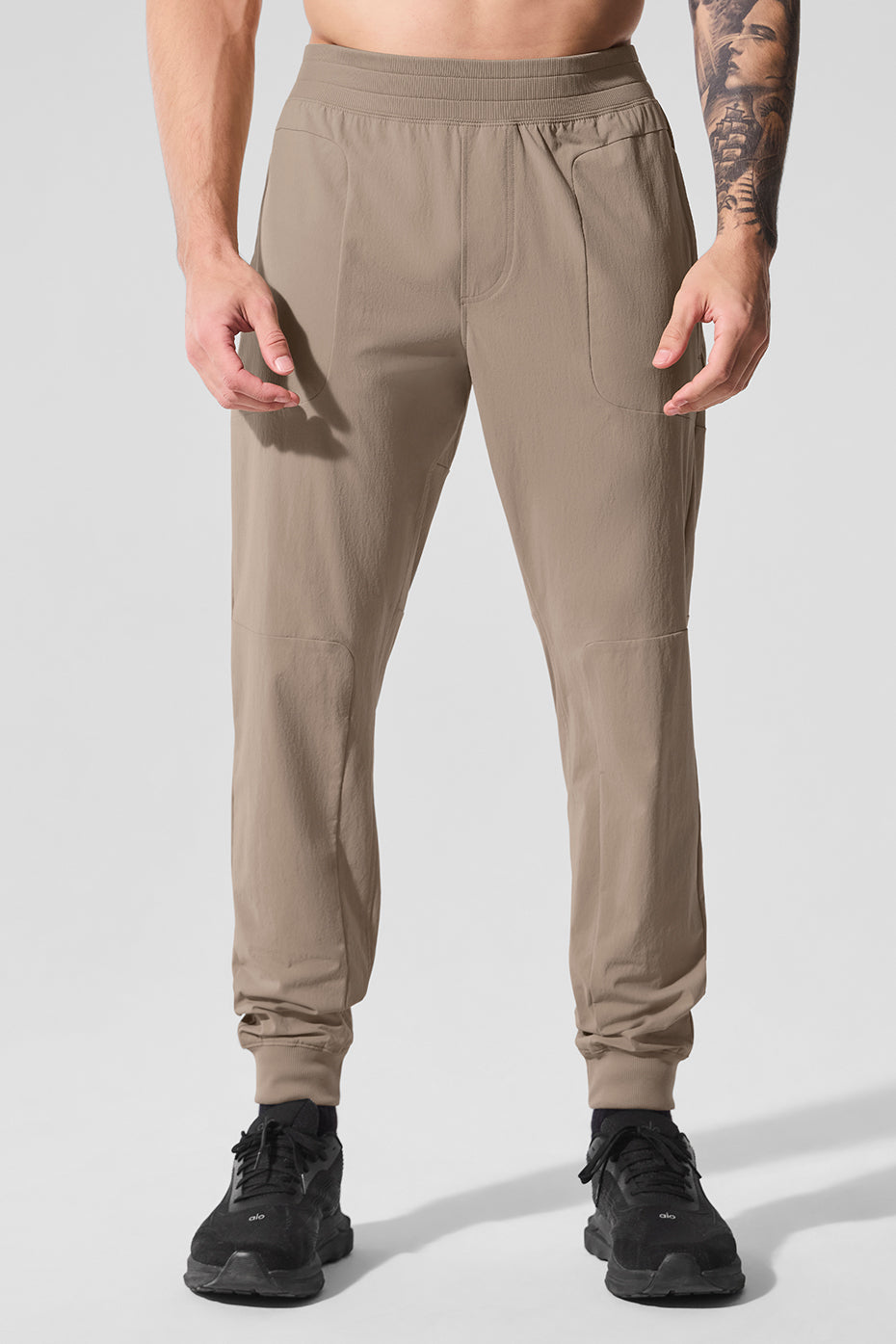 Stretch active pants in gravel with side-zip pockets for outdoor use.