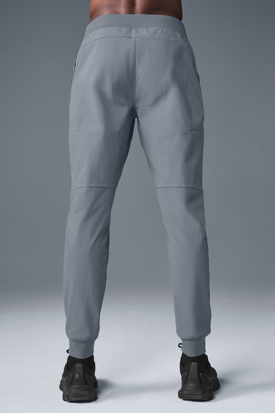 Model in motion wearing Roundtree & Yorke active pants on urban trail