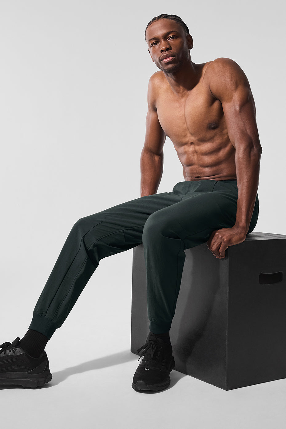 Close-up of water-repellent fabric on mens athletic pants in Charcoal Green