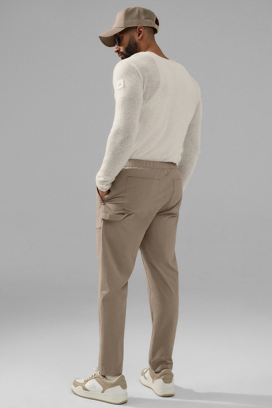 Model wearing pants track style in an urban setting, highlighting relaxed fit.