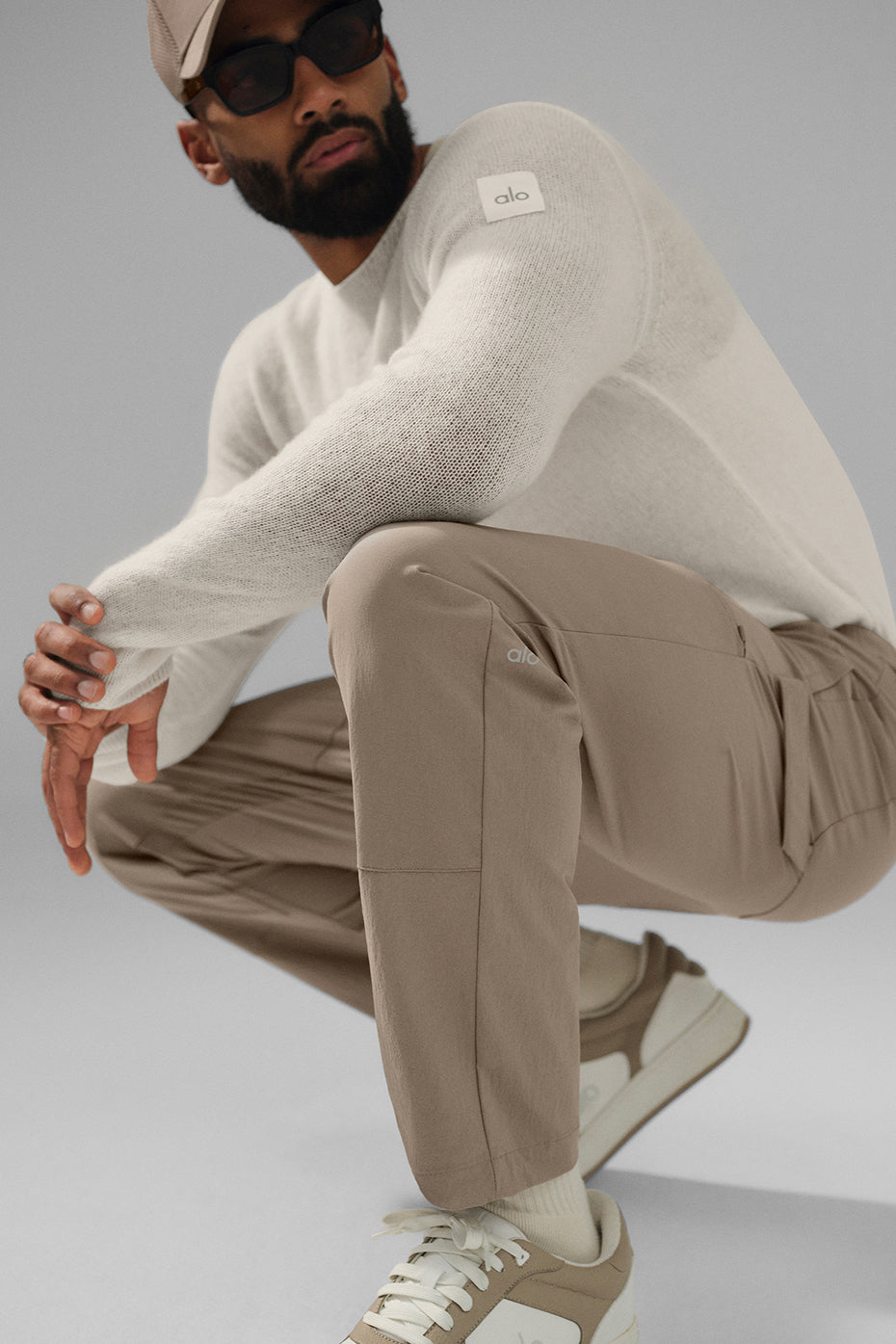 Model wearing pants track style in an urban setting, highlighting relaxed fit.