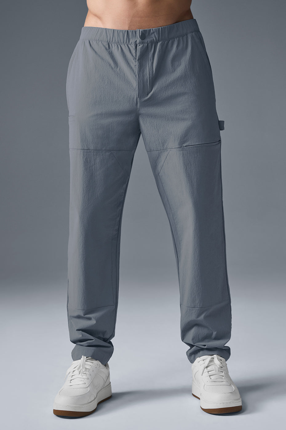 Front view of steel grey carpenter pants showcasing pockets and fit.