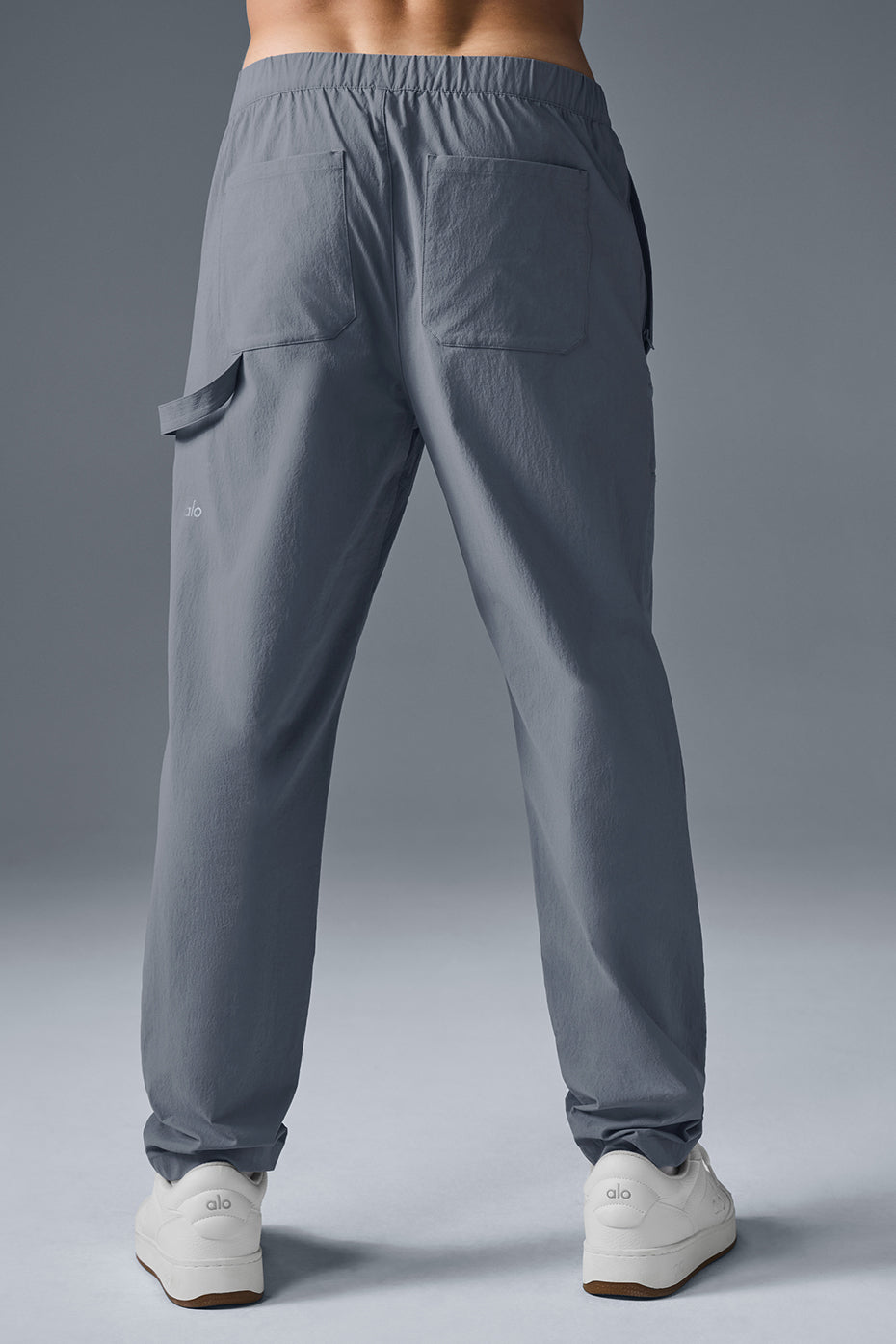 Side angle of urban utility carpenter pants highlighting cargo paneling.