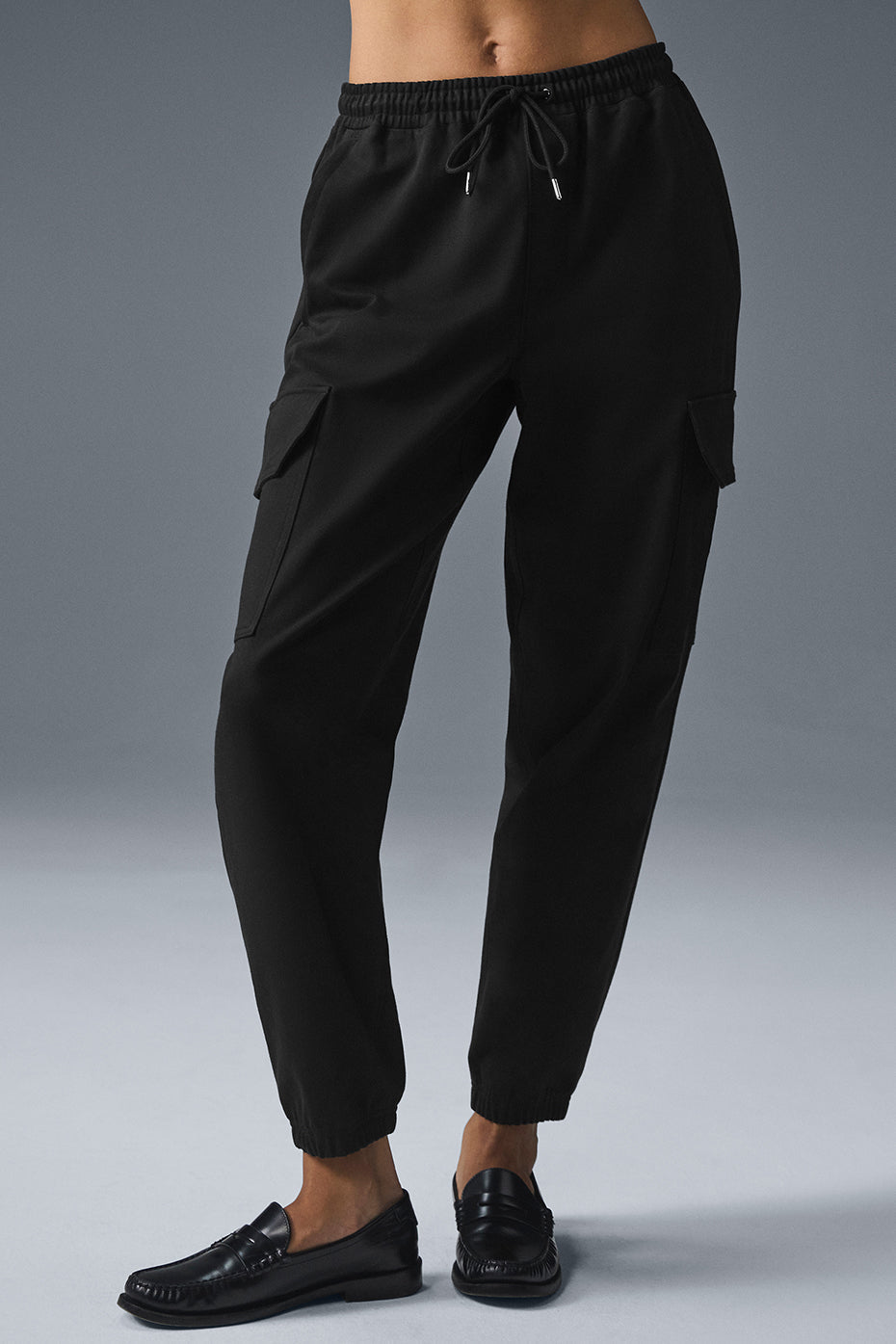 Close-up of sleek sueded joggers showcasing fabric texture and drawcord waist.