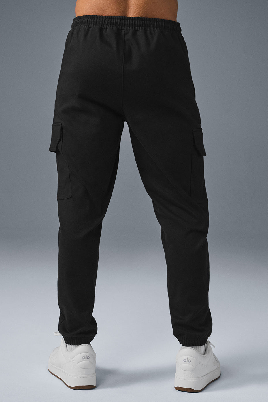 Close-up of cinched cuffs on black joggers, perfect for a trendy look.