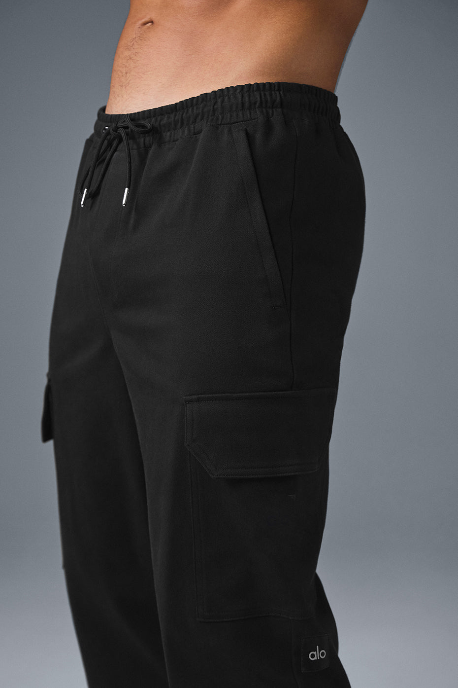 Model wearing black joggers paired with a matching jacket for a coordinated outfit.