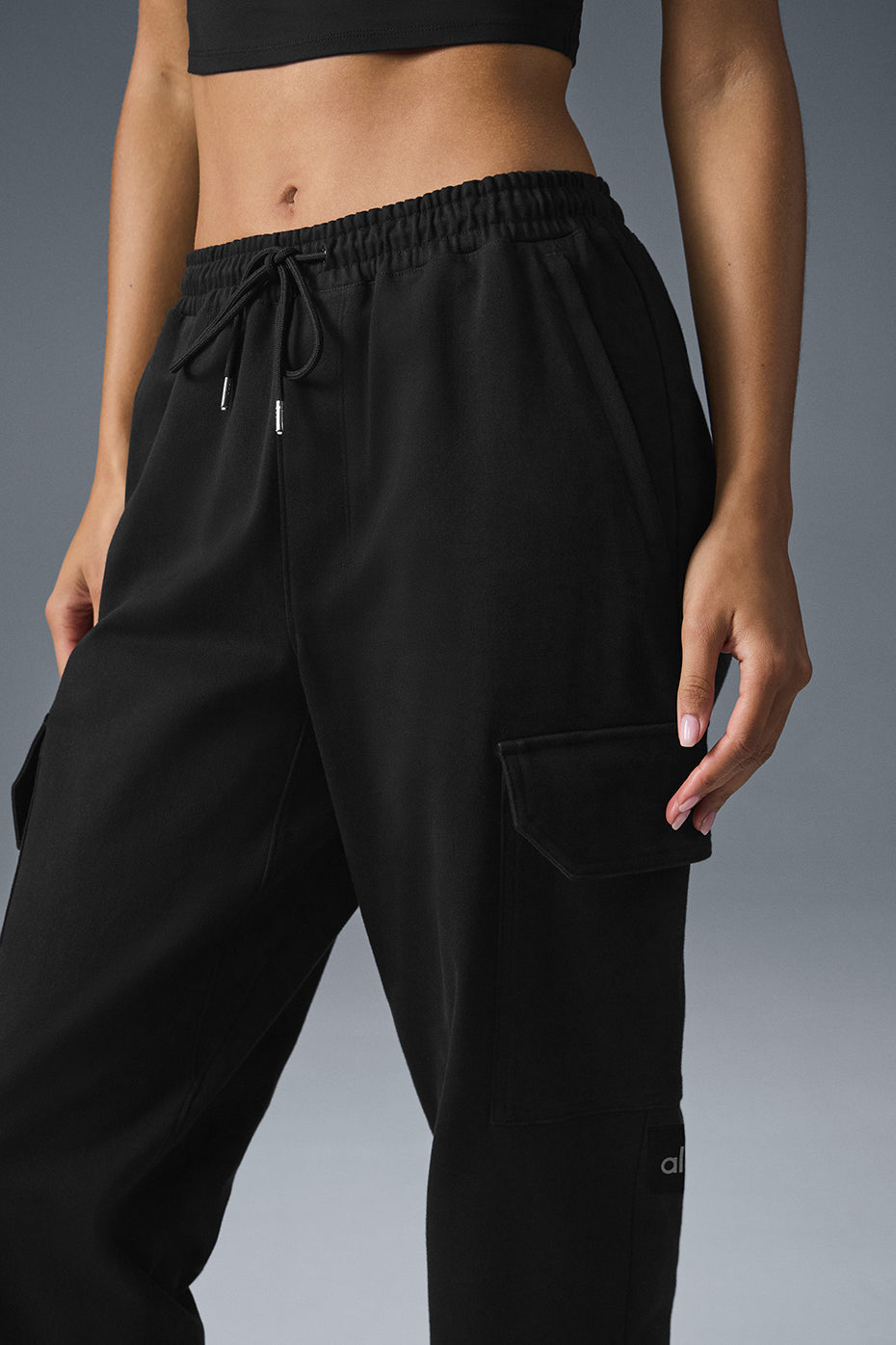 Close-up of sleek sueded joggers showcasing fabric texture and drawcord waist.