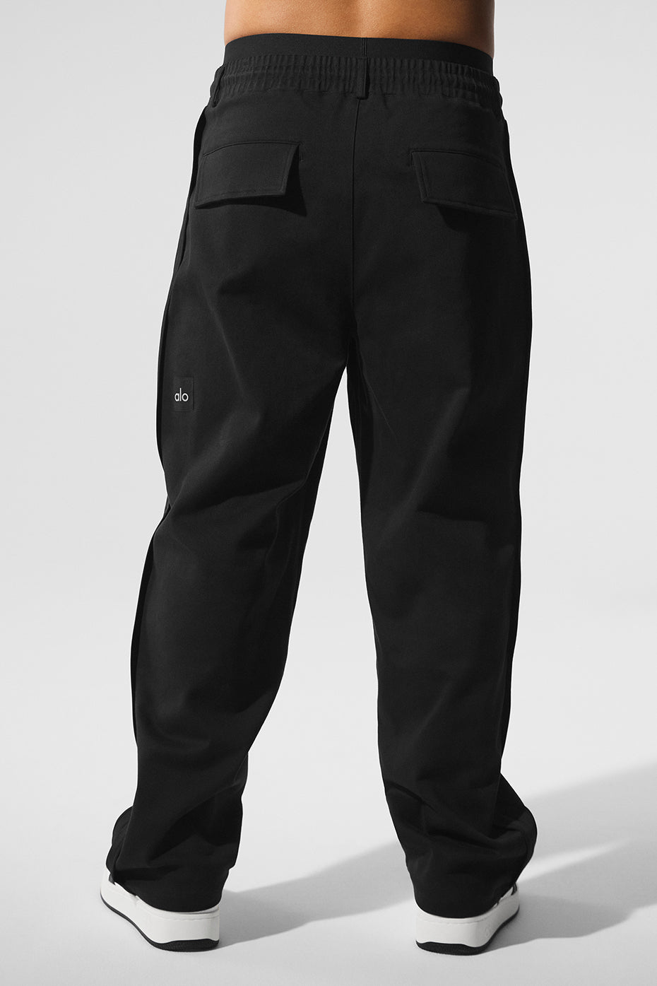 Close-up of the zippered side pocket on black pull-on pants