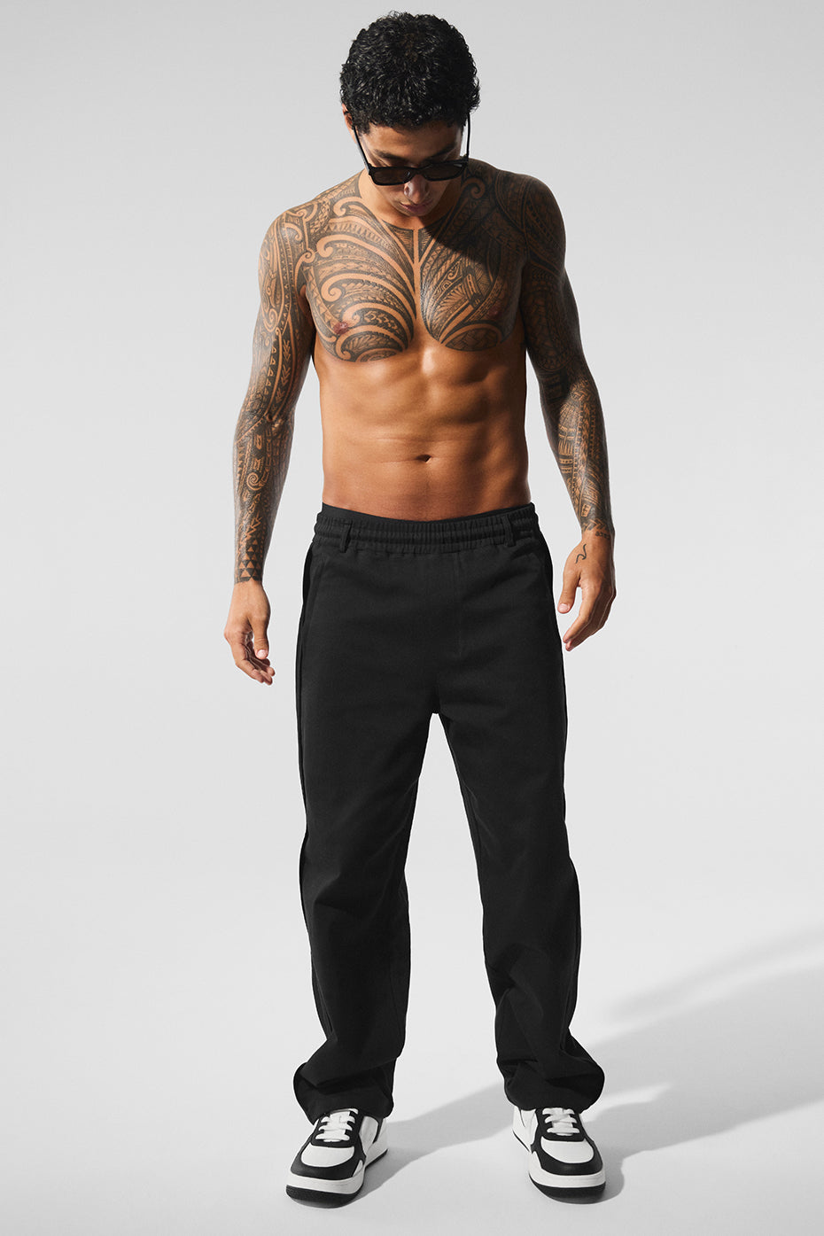 Front view of women’s black sueded pants with straight-leg cut and belt loops