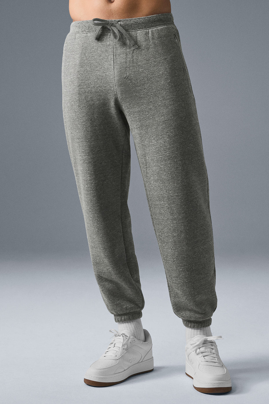 Men wearing dark grey fleece sweatpants in a relaxed setting