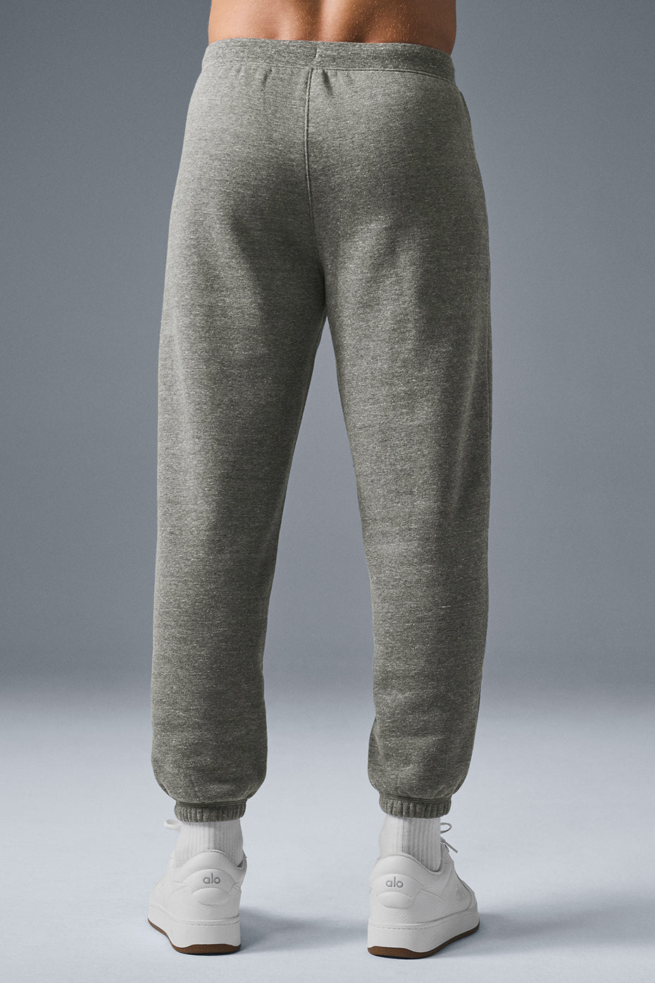 Close-up of the fleece fabric and drawcord waist on grey sweatpants