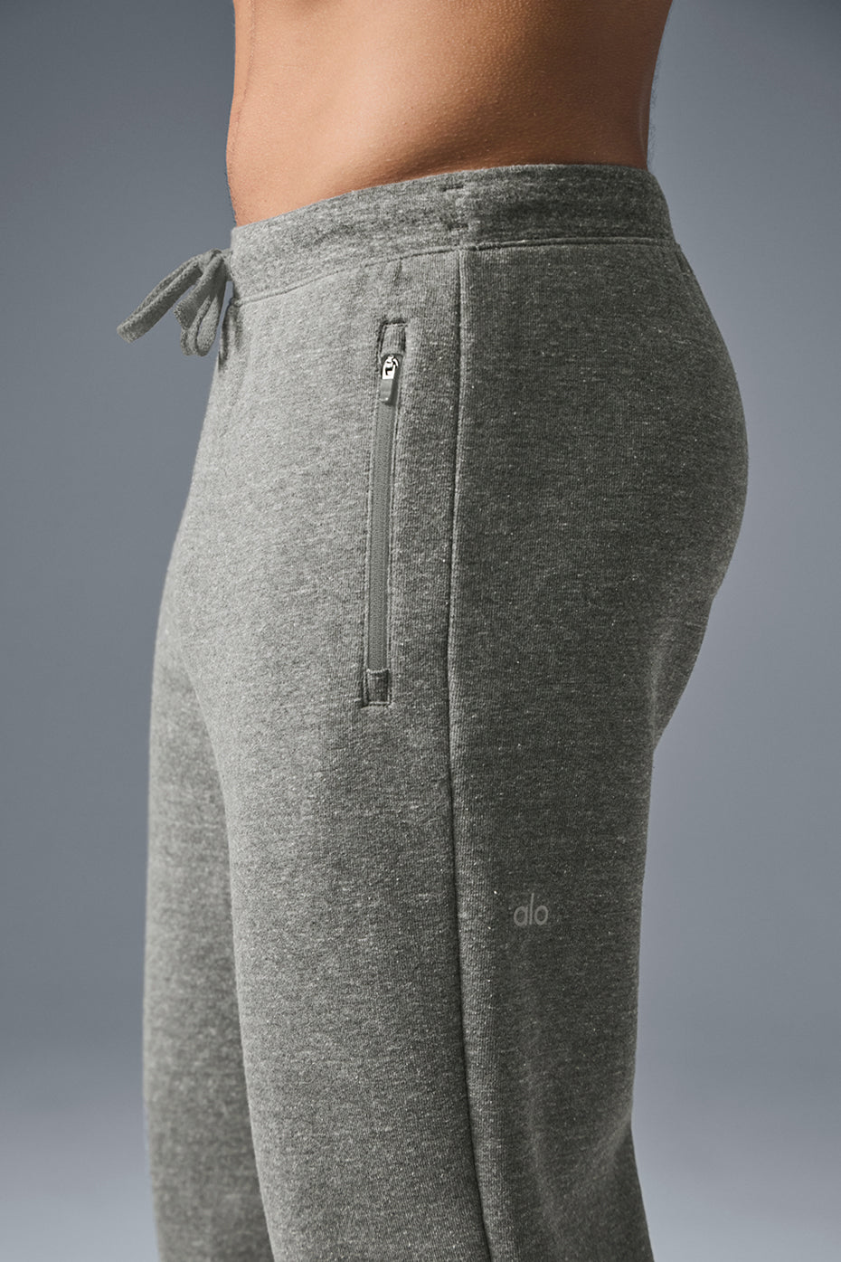Oversized sweatpants folded to show fabric texture and zippered pockets