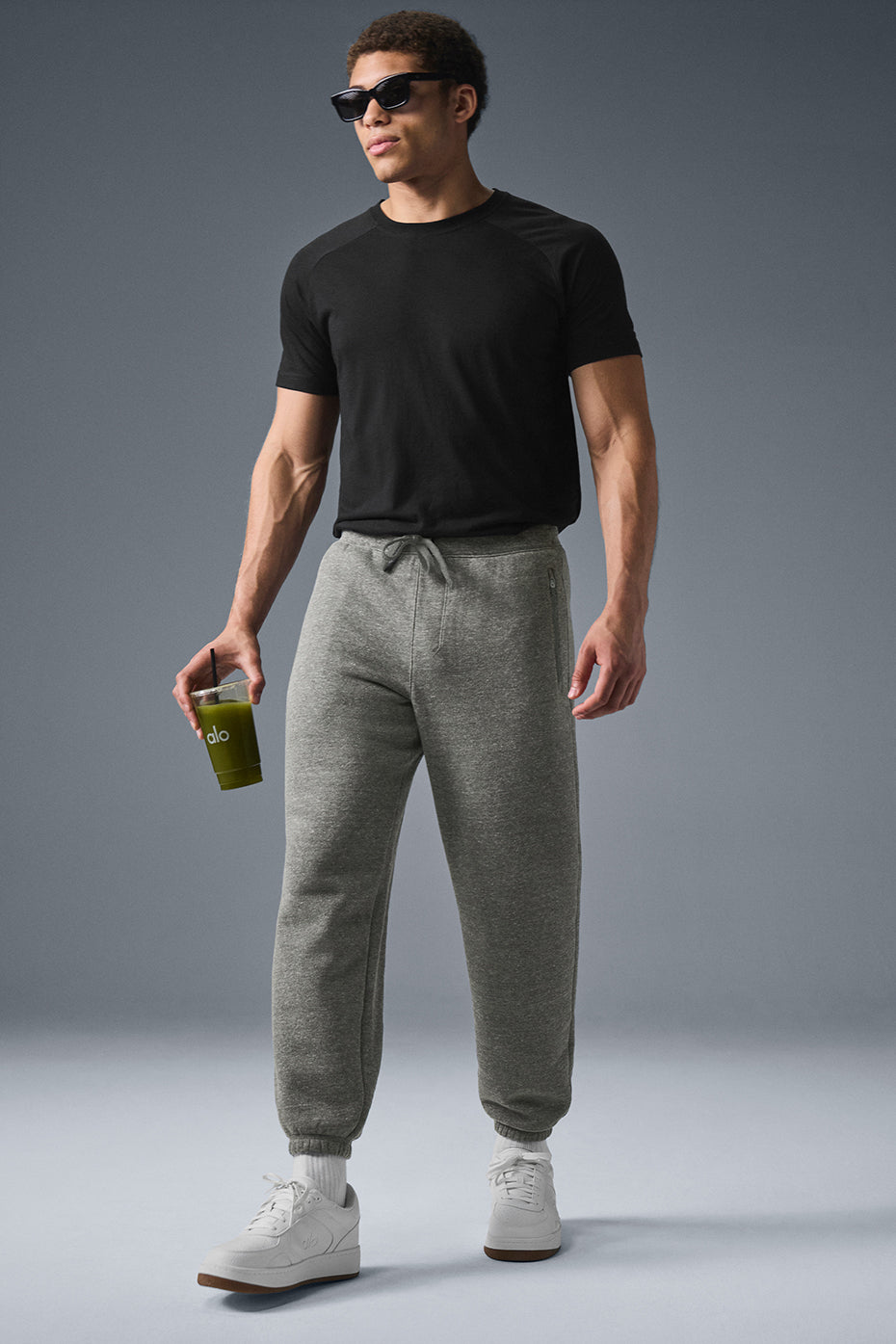 Men wearing dark grey fleece sweatpants in a relaxed setting
