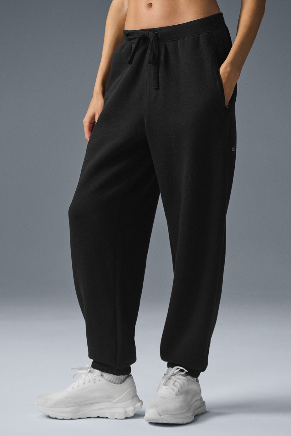 Black baggy sweatpants displayed on a casual outfit setting.