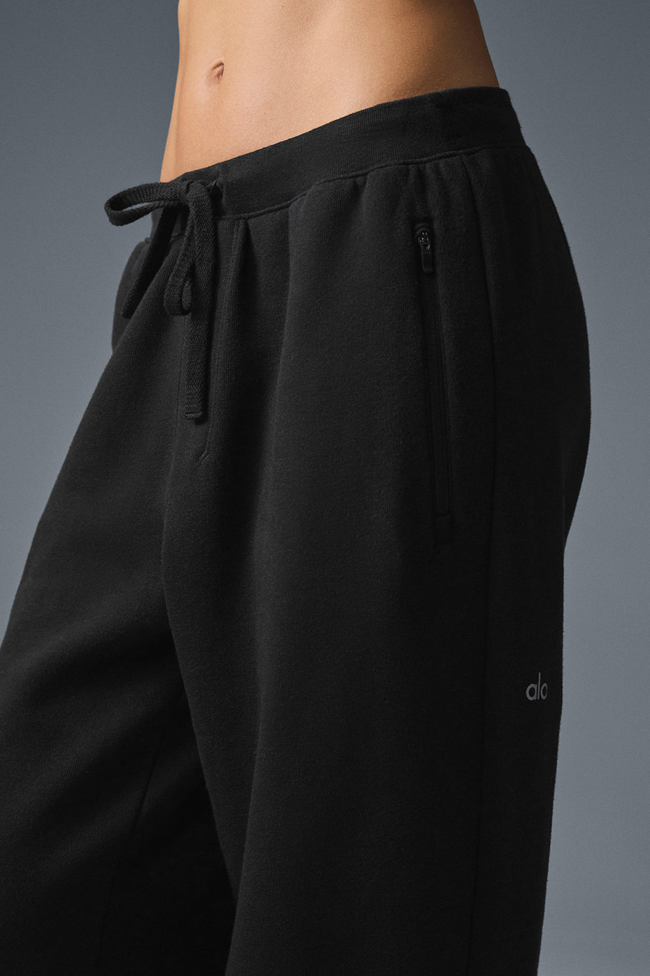 Black baggy sweatpants displayed on a casual outfit setting.