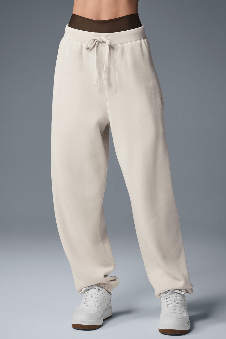 Front view of Triumph Restore baggy sweatpants in bone color, showcasing the relaxed fit.