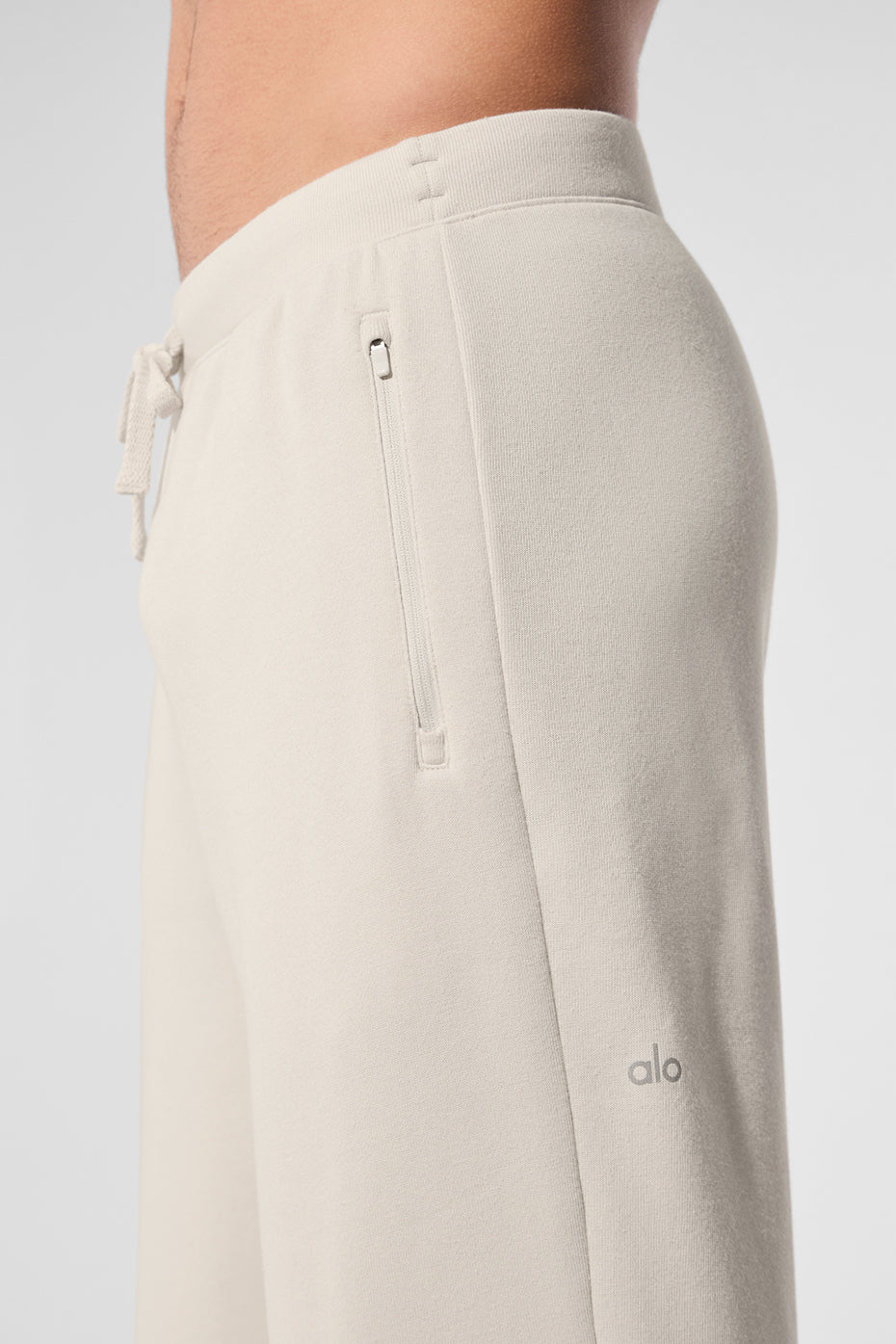 Front view of baggy sweatpants styled with white sneakers and crew neck hoodie