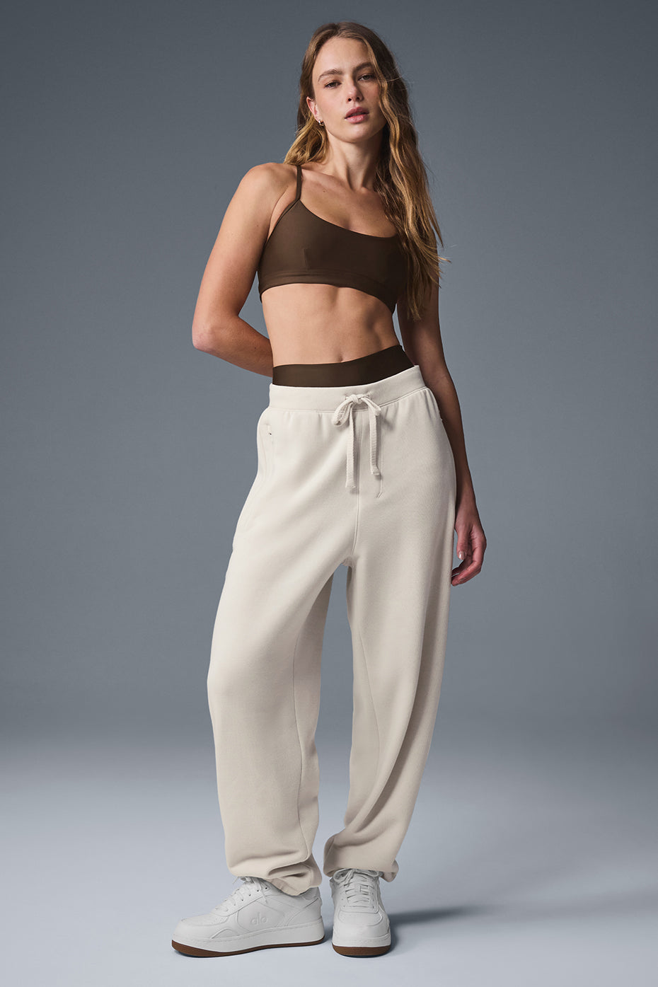 Front view of Triumph Restore baggy sweatpants in bone color, showcasing the relaxed fit.