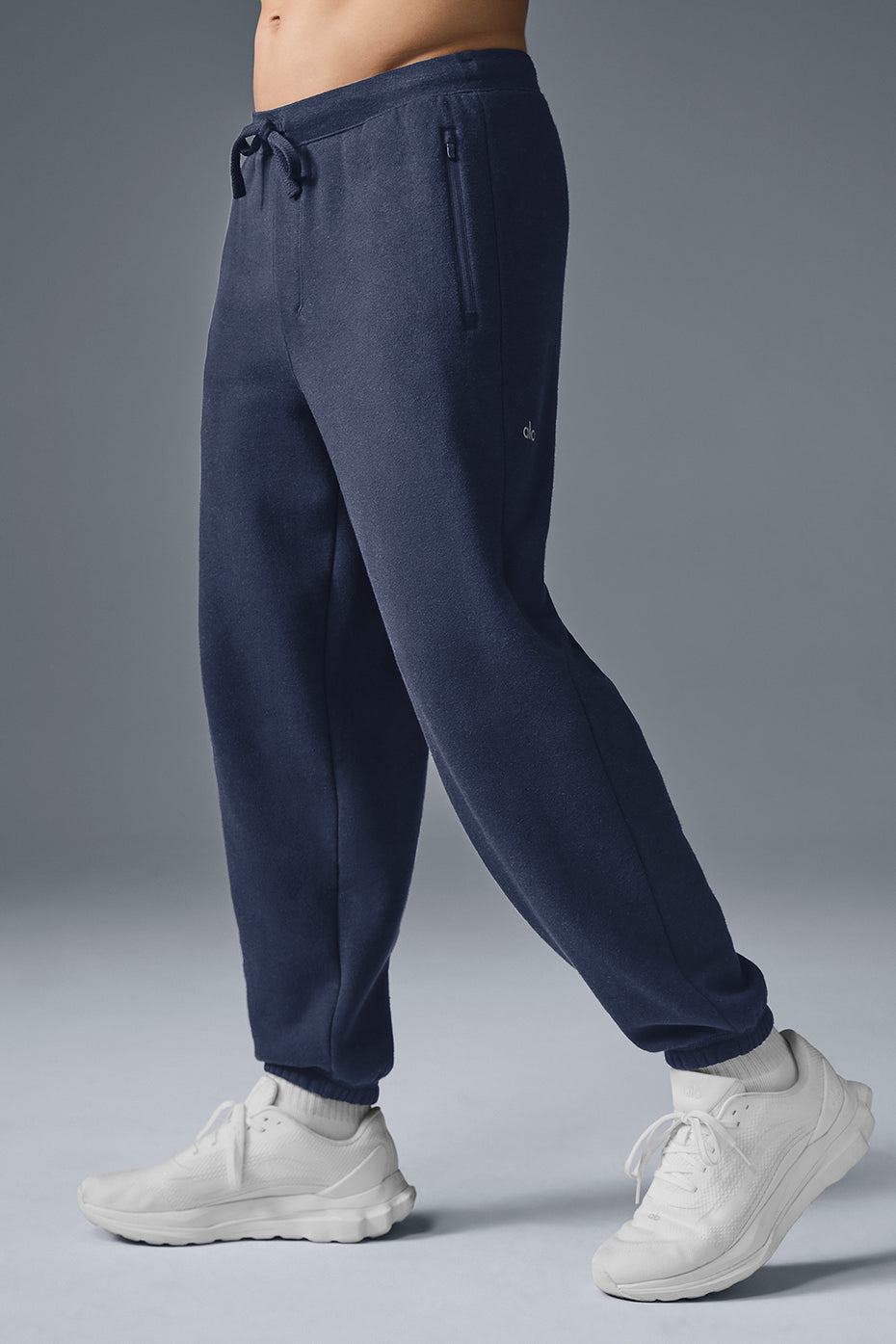 Back view showing wide leg fit and waistband drawcord on fleece sweatpants.