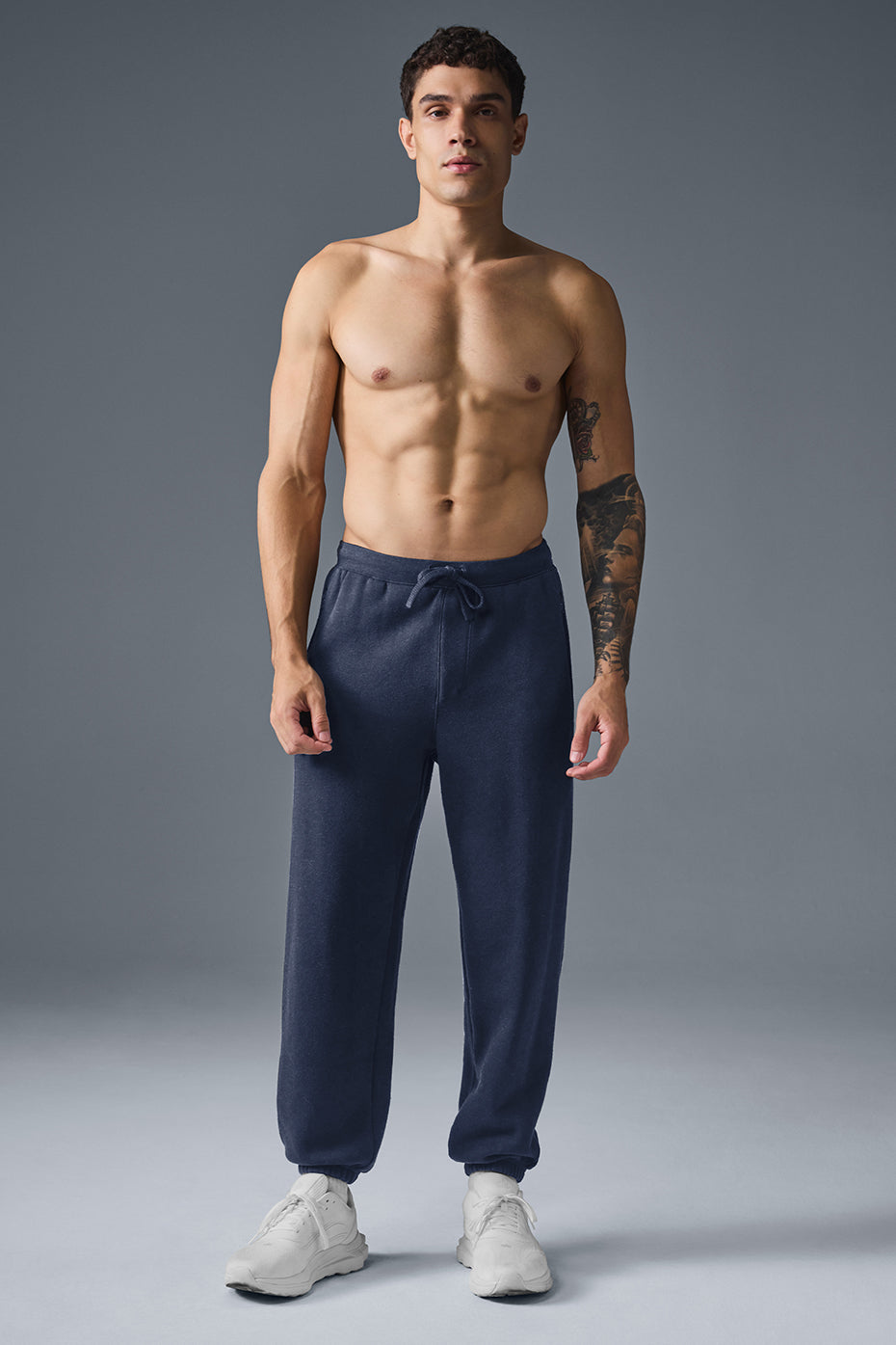Zippered pocket detail and cuffed ankle close-up of mens sweatpants.