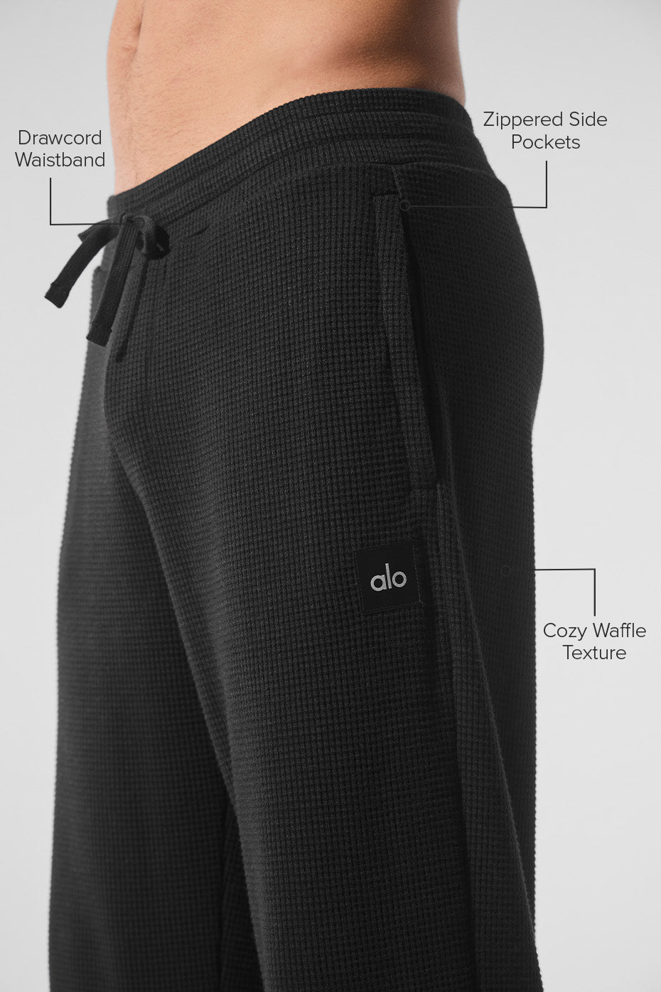 Close-up of the drawcord waistband of the black waffle pants.