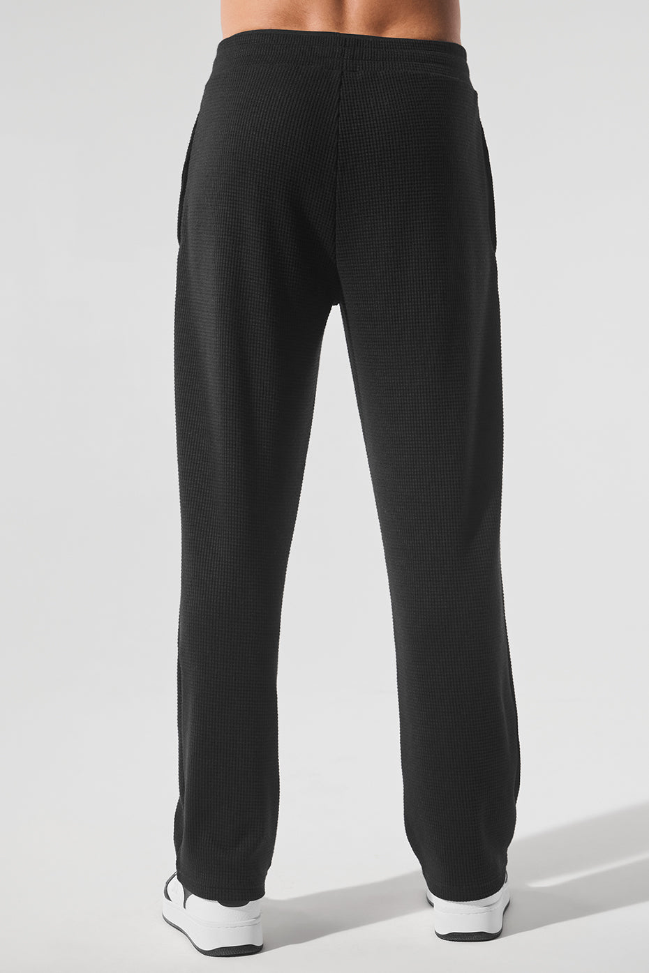 Zippered side pockets of the straight leg pants displayed in a casual setting.