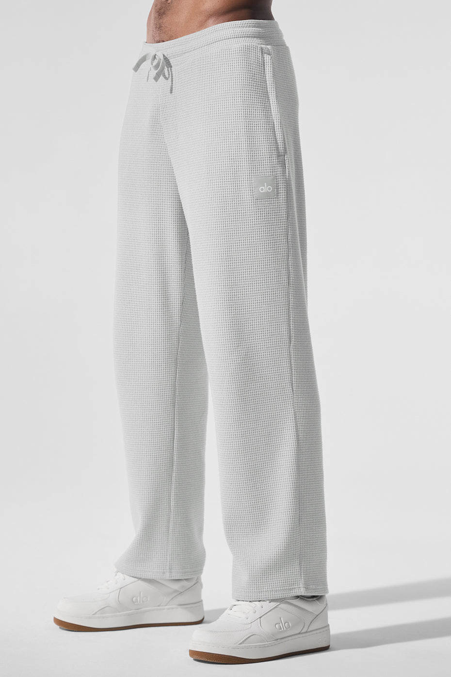 Model wearing Elevate waffle pants with a relaxed fit in Heather Grey, suitable for athleisure wear.