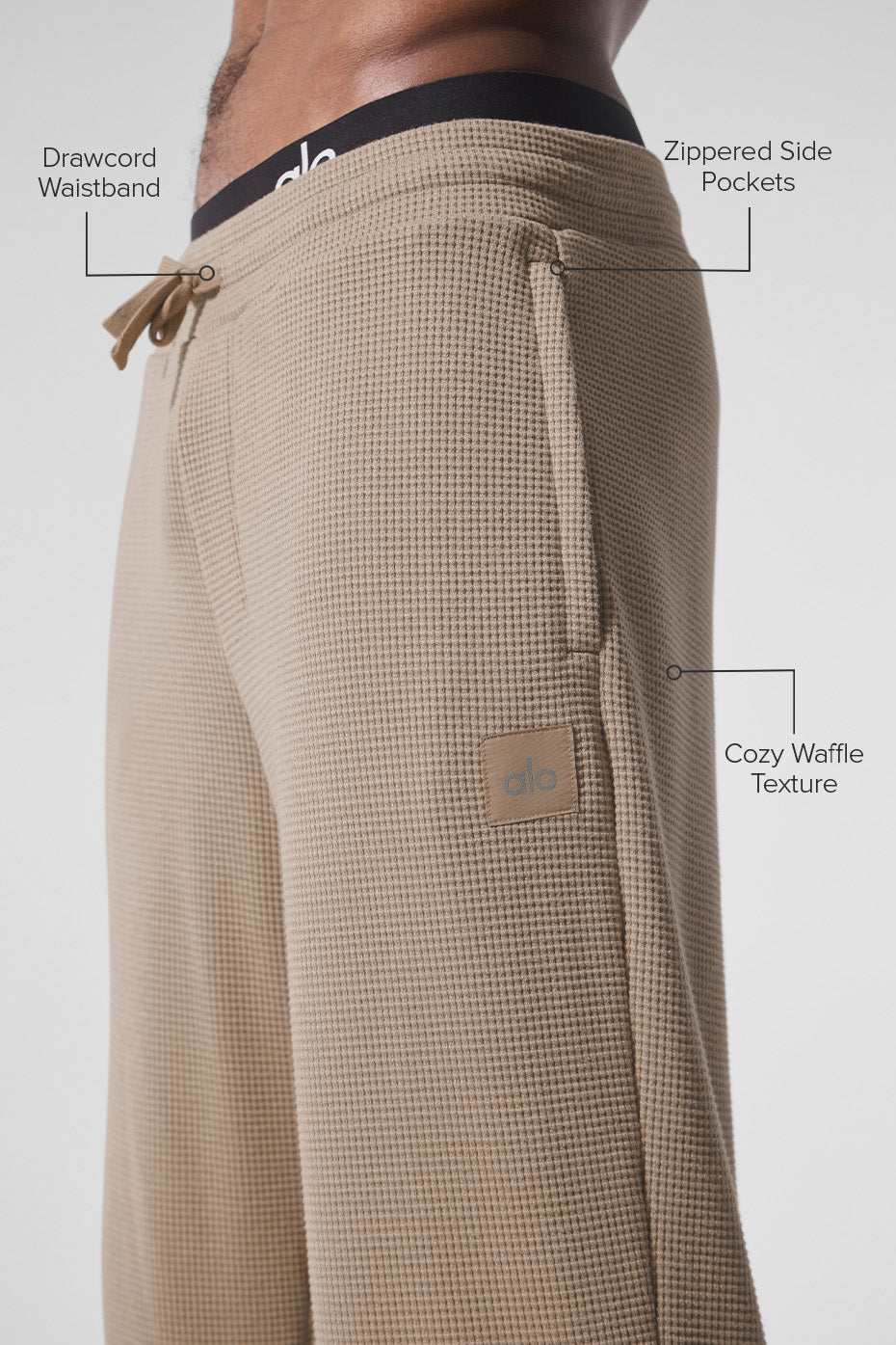 Side profile of waffle pants with drawcord waistband and zippered pockets