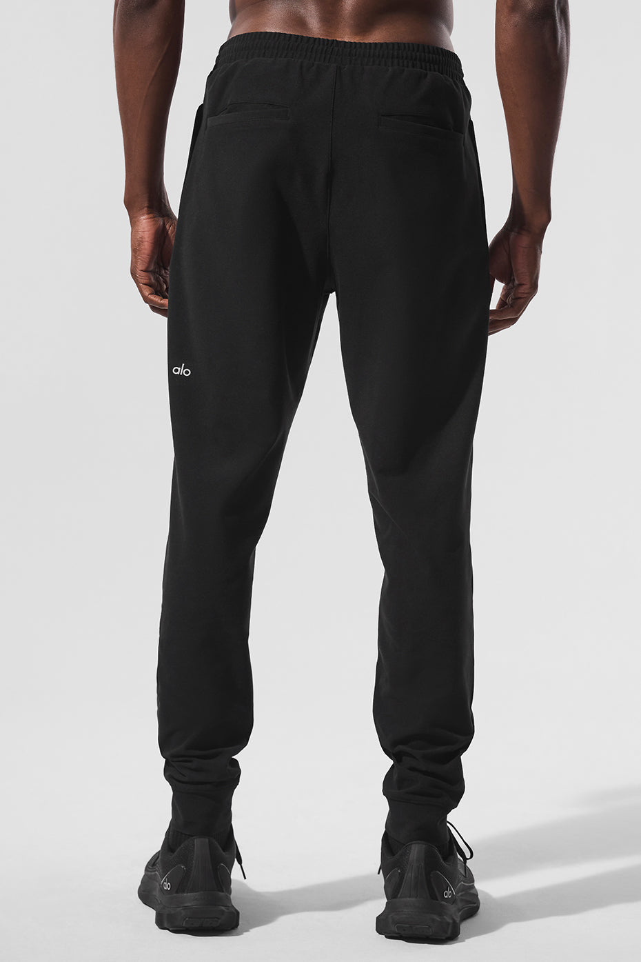 Side view showcasing the stretch and fit of mens black joggers.