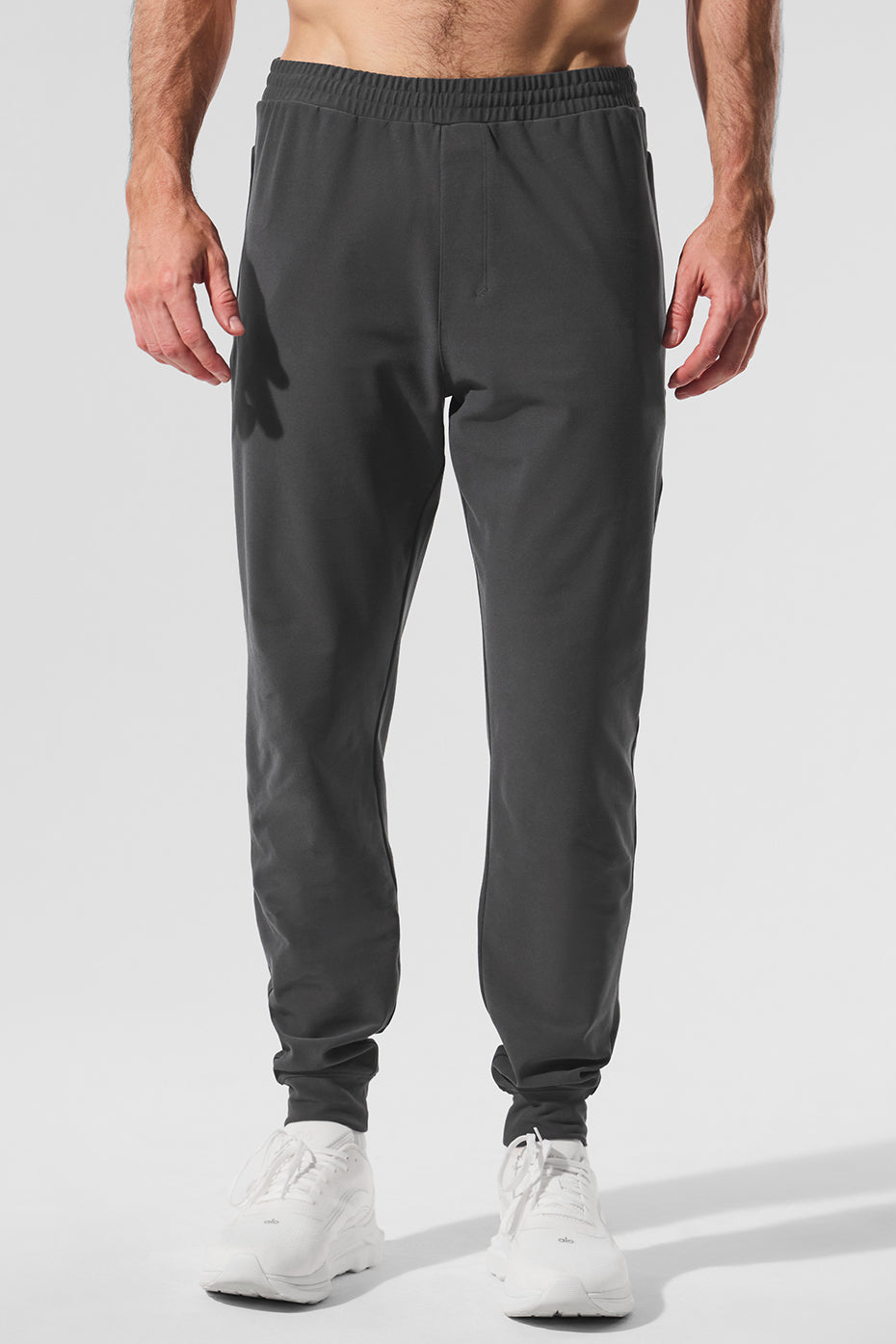 Close-up of men's performance joggers highlighting the stretch fabric and fit.
