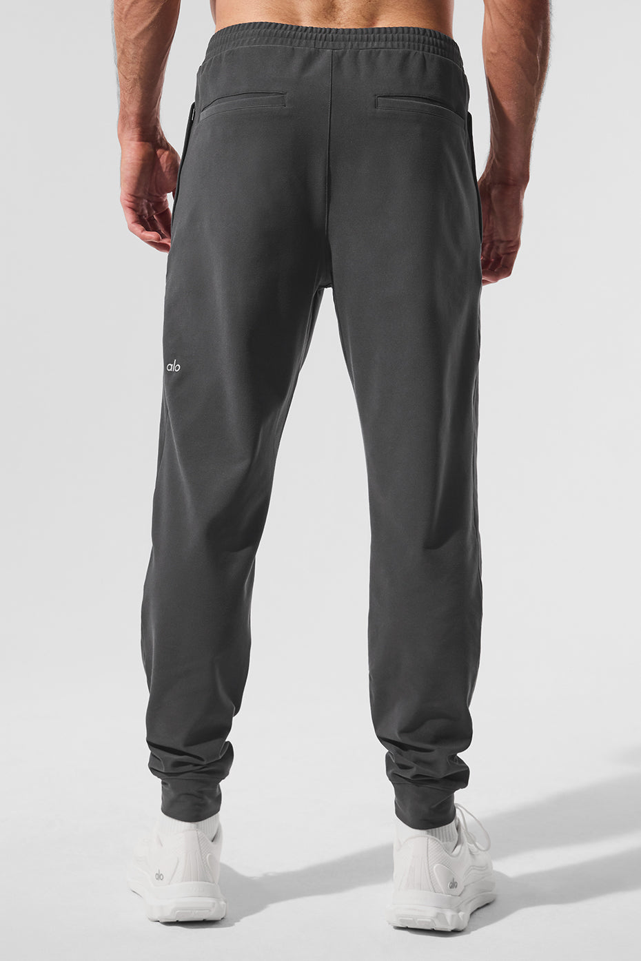 Model wearing performance joggers during a workout in the gym.